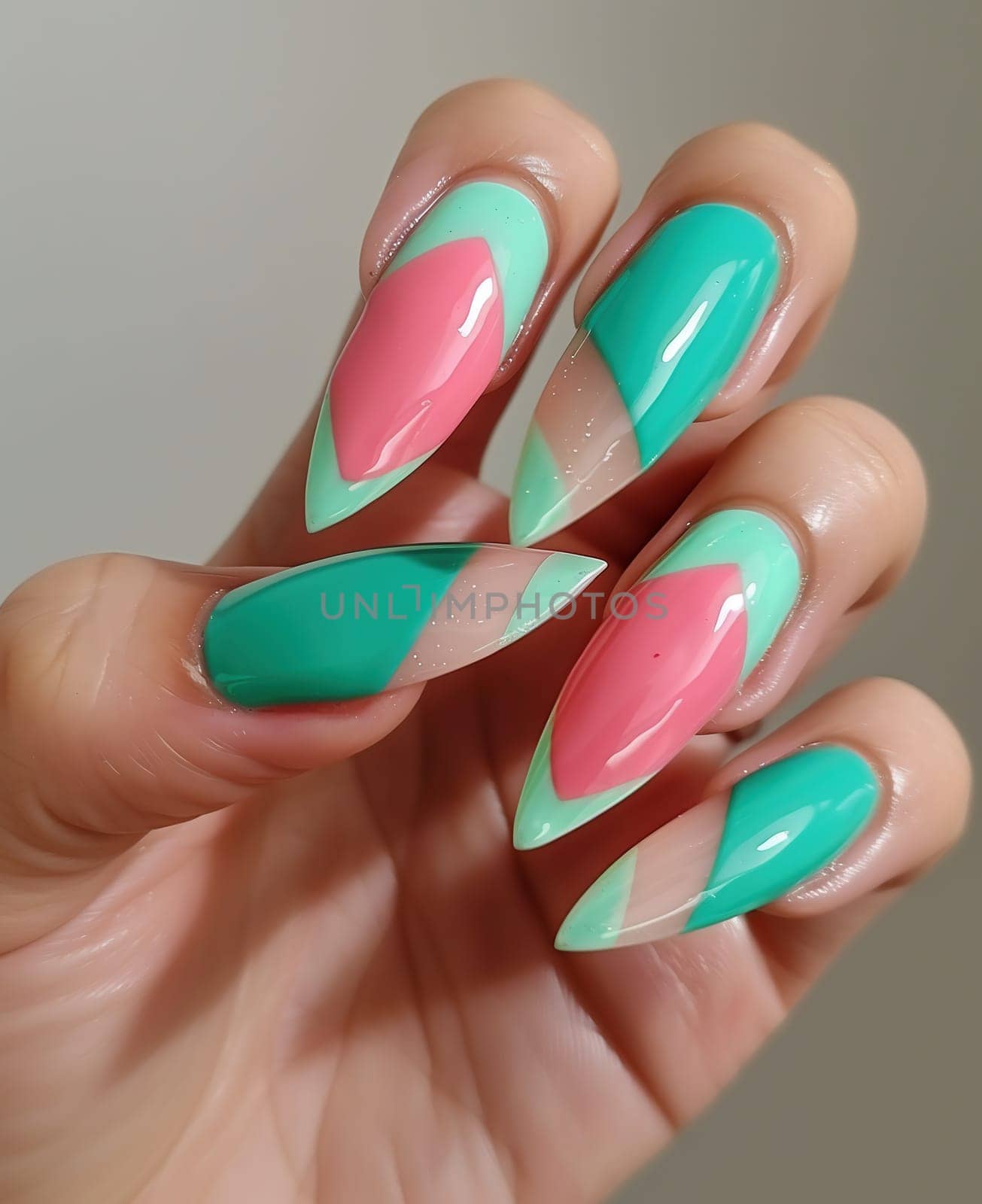 Female hand with long nails and bright green manicure with bottles of nail polish by Andelov13