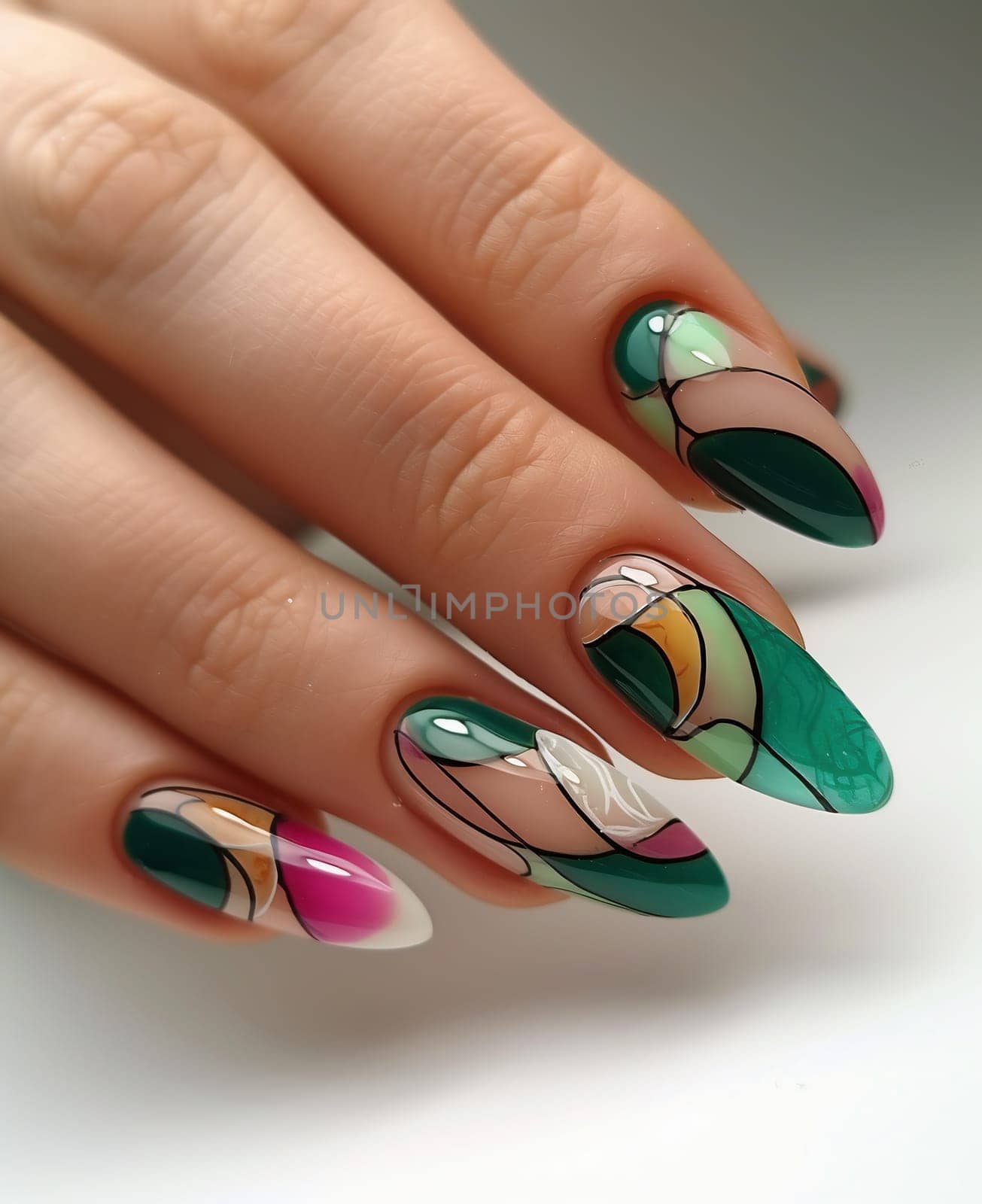 Female hand with long nails and bright green manicure with bottles of nail polish by Andelov13
