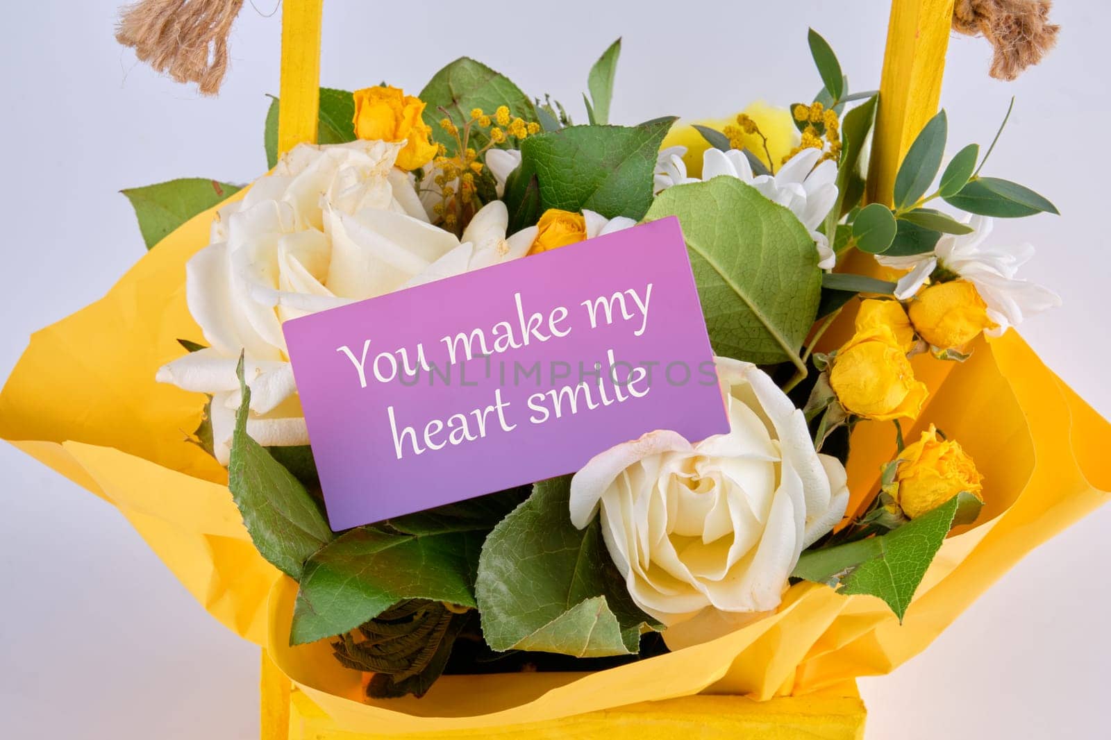 You Make My Heart Smile text on a business card in a basket with blooming flowers