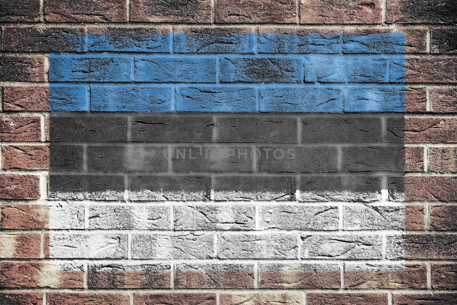 An Estonia flag painted on brick wall background