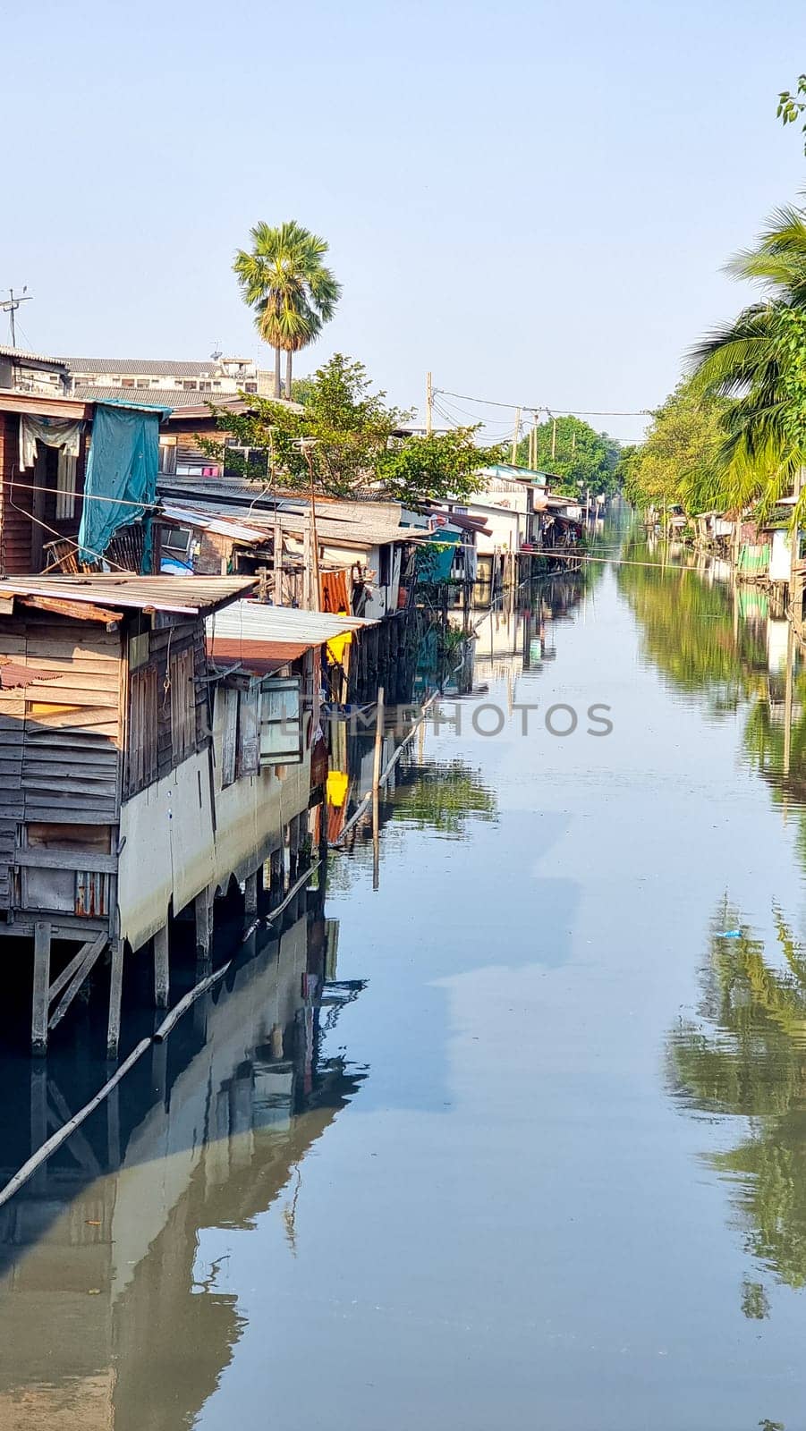 Bangkok Thailand 13 January 2024, , Serene body of water featuring charming houses floating on its surface, creating a picturesque scene of unique living arrangements.