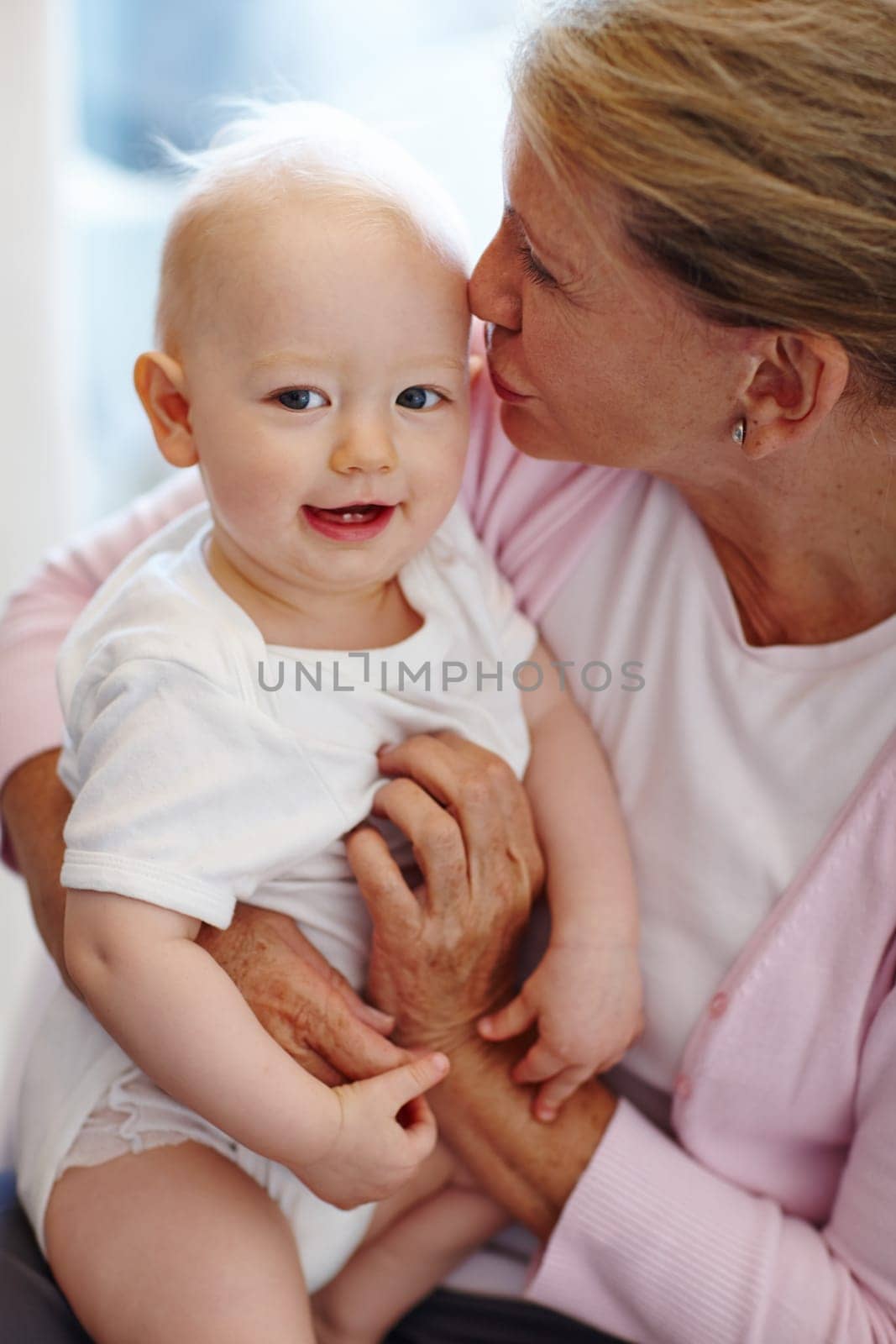 Happy, baby and grandmother kiss in portrait with love for family, bonding and development. Cute, child and grandma hug at home together with attention, kindness and care while babysitting newborn.