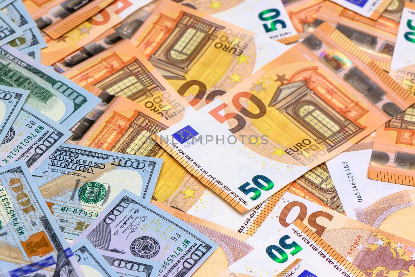 Banknotes of 100 dollars and 50 euros laid out on the table by Mixa74