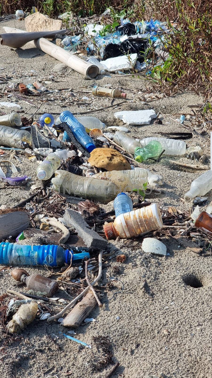 A chaotic array of glass bottles scattered on the ground, creating a stunning visual landscape of colors and shapes. Chantaburi Thailand