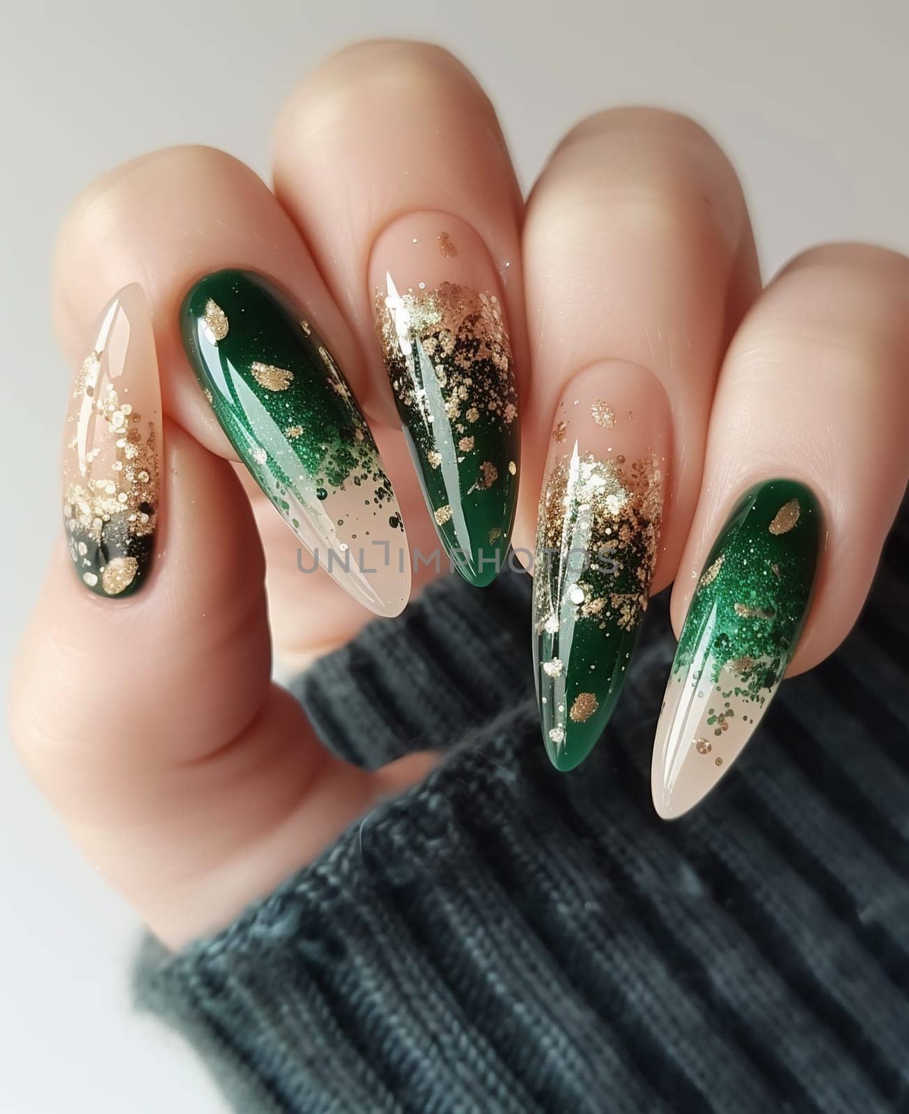 Female hand with long nails and bright green manicure with bottles of nail polish by Andelov13