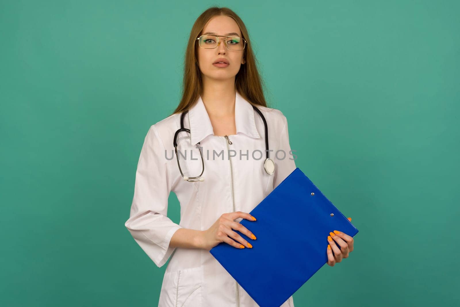 Beautiful young girl nurse or trainee doctor with blue folder and statoscope on a blue background by zartarn