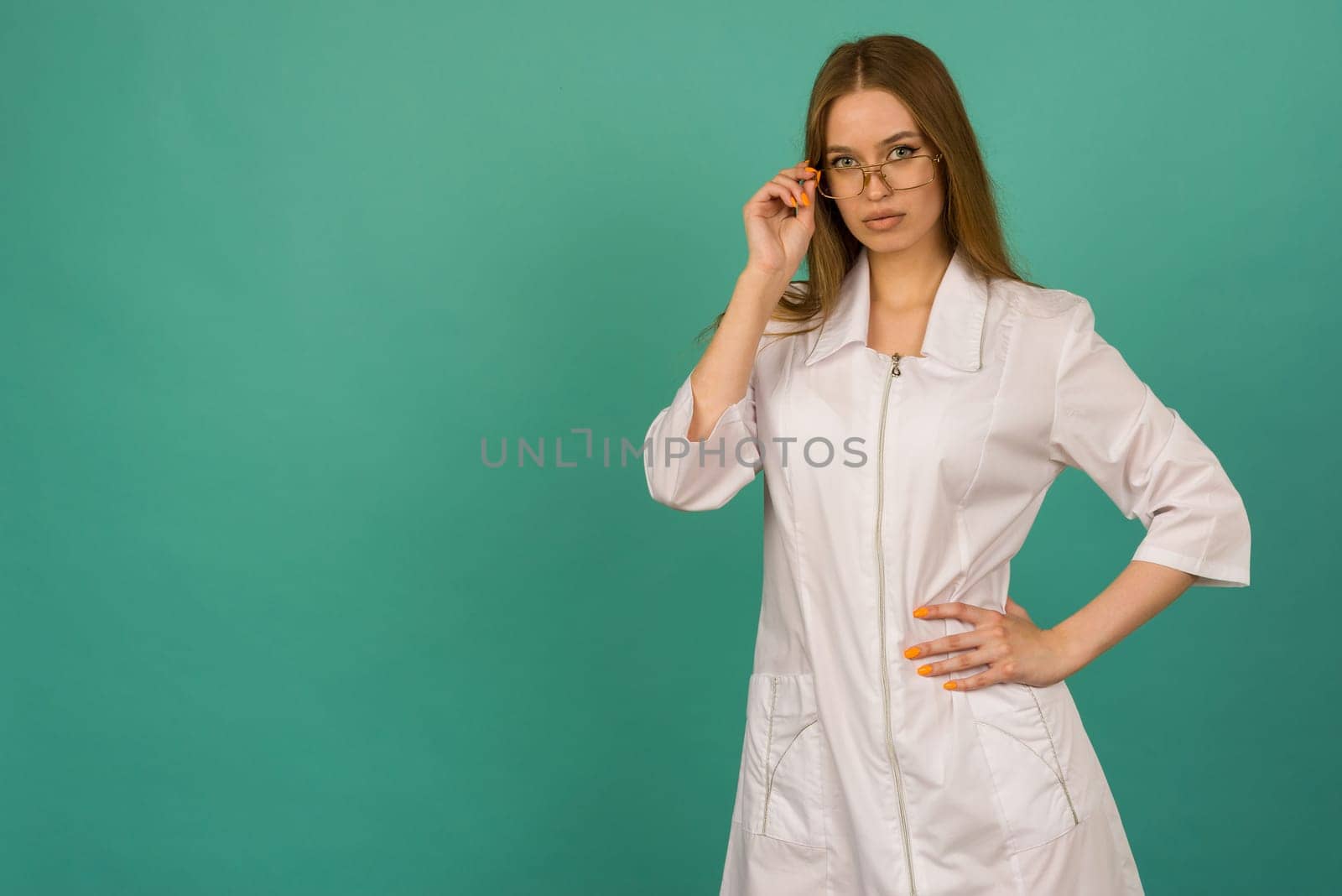 Beautiful smiling sexy nurse or femele doctor standing isjlated on background .