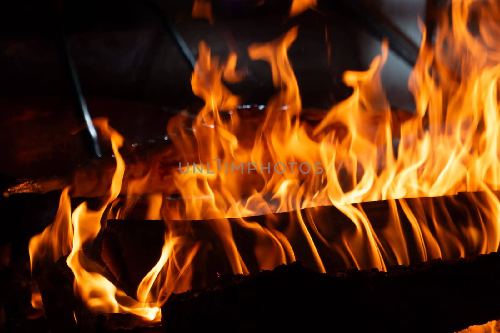 Close up shot of burning firewood in the fireplace. by FreeProd