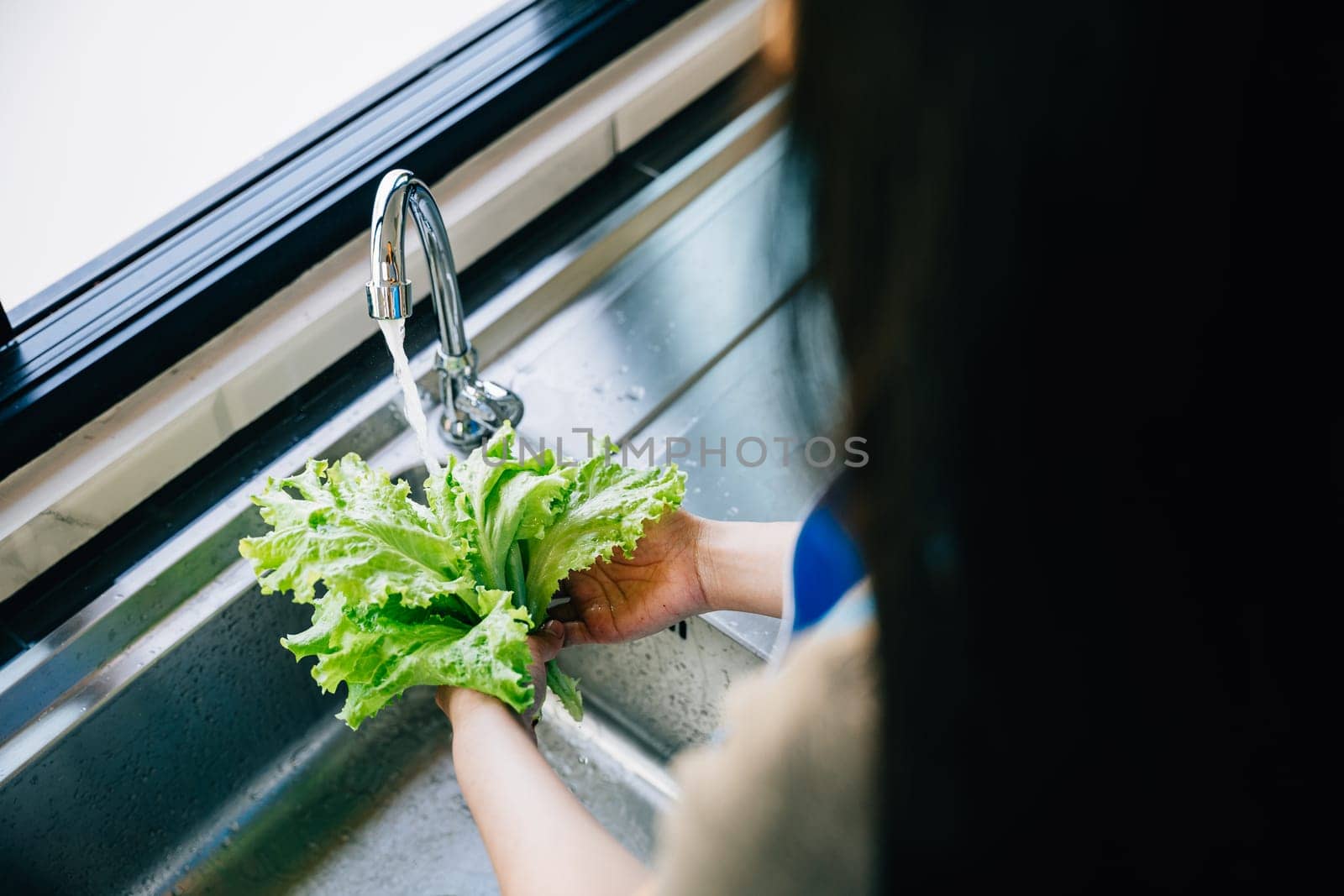 Bright clean vegetables being washed by Sorapop