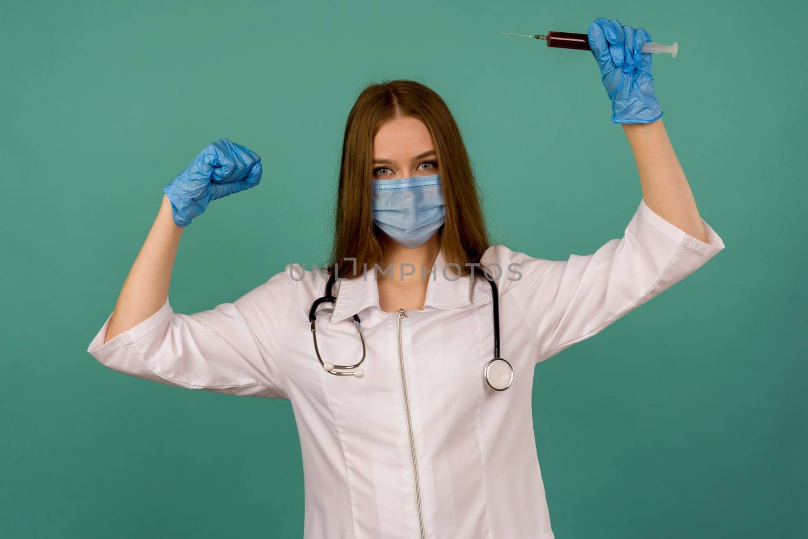 Covid19, coronavirus. Portrait of professional confident young caucasian doctor in medical mask and white coat, stethoscope over neck,with vaccine syringe in hand, fight disease - image