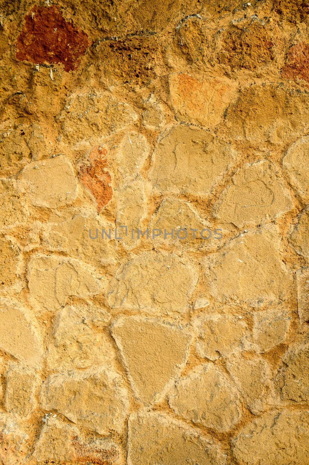A solid beige colored stone wall suitable for the background. by Mixa74