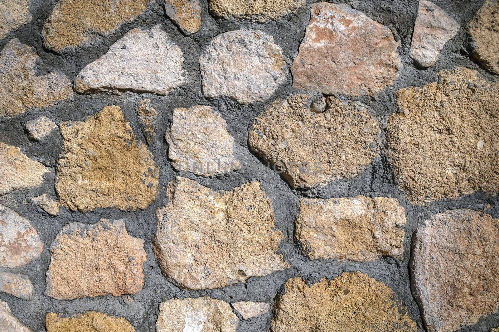 Ancient brick wall background. Texture of an ancient sandstone brick wall.