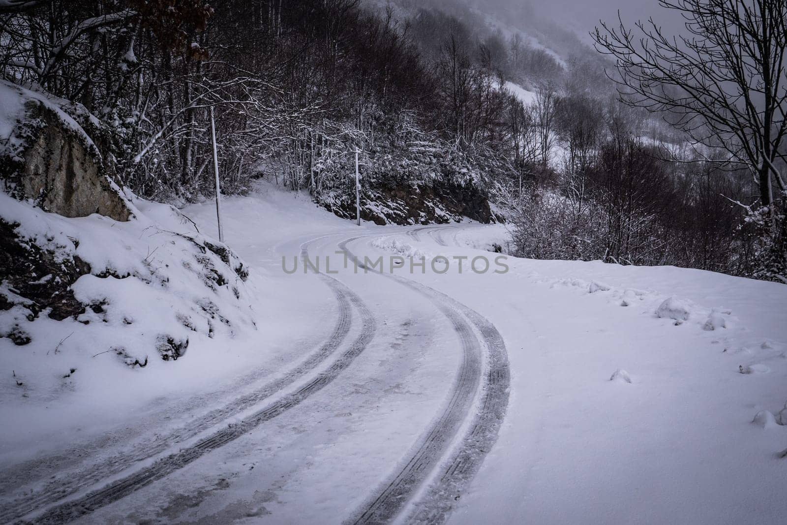 Snowy road with grey sky in pyrenees mountains, High quality photo