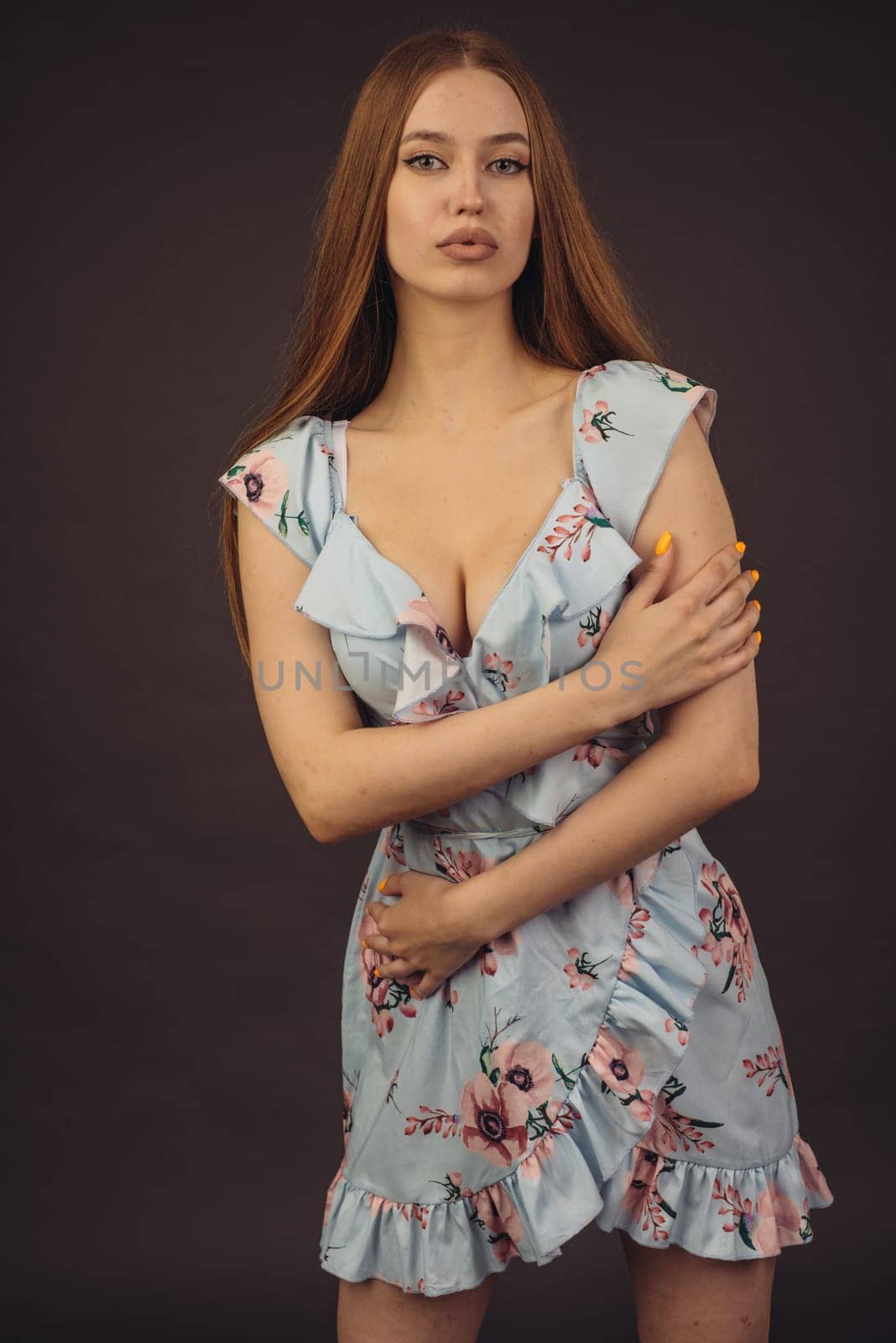 Young attractive woman posing in the studio. A full-lipped girl has problems with skin on her face and body, disease of psoriasis. She does not lose heart and lives a full life wants to become a model