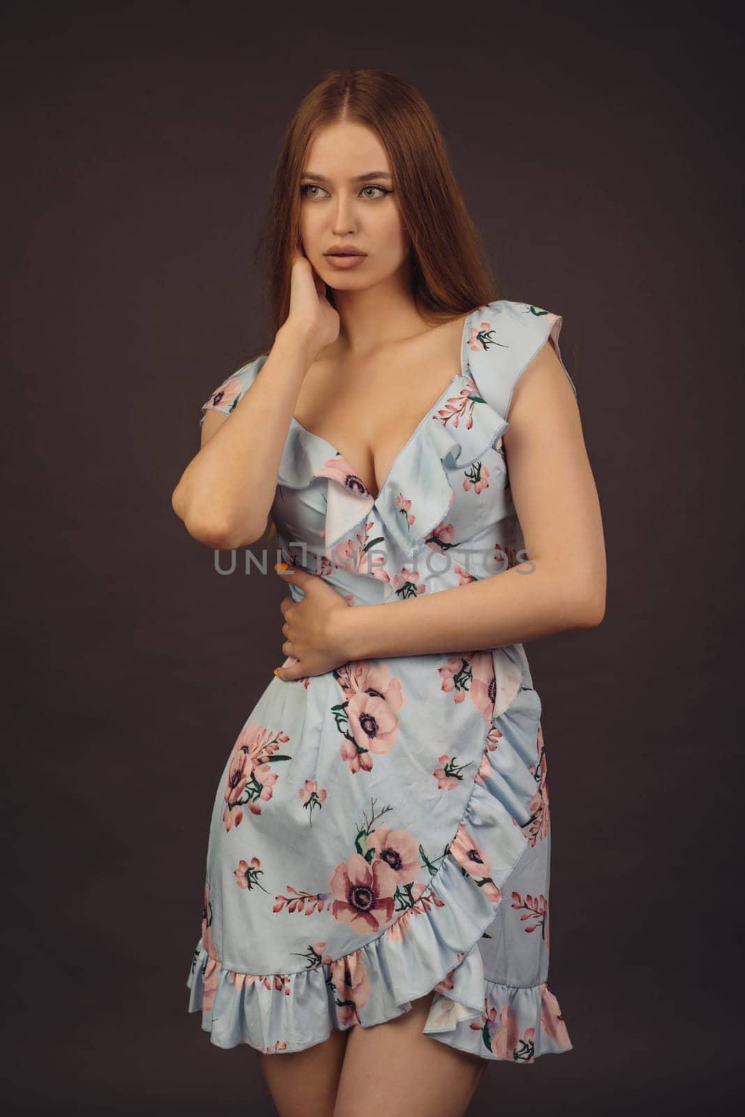 Beautiful young puffy lips woman in floral dress posing in studio. - image