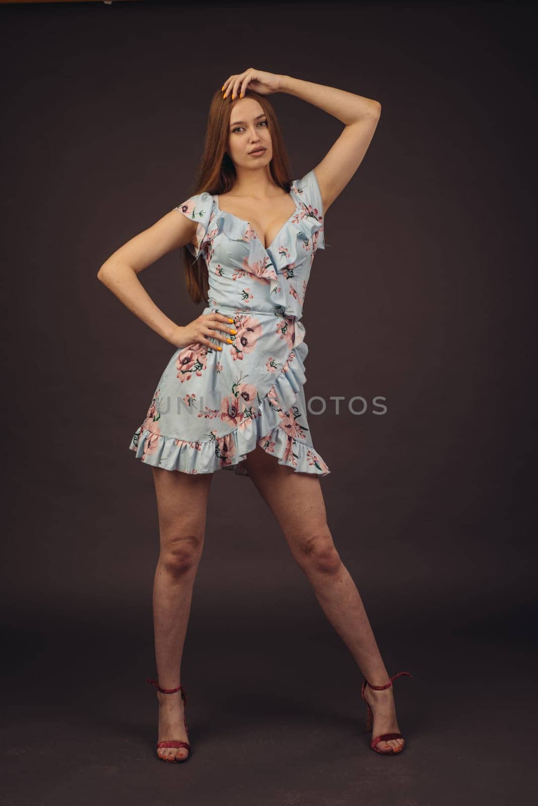 Young attractive woman posing in the studio. A full-lipped girl has problems with skin on her face and body, disease of psoriasis. She does not lose heart and lives a full life wants to become a model