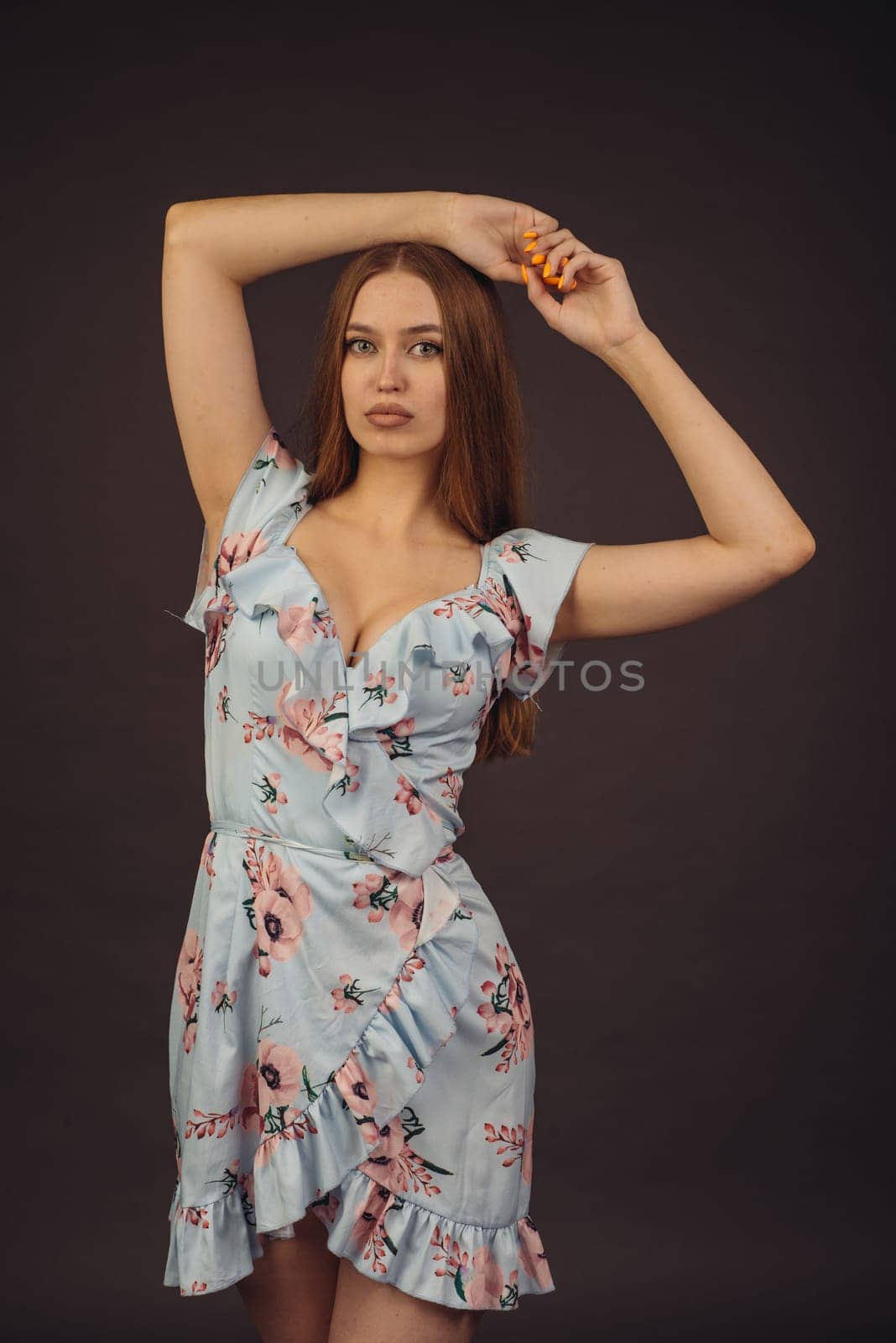 Young attractive woman posing in the studio. A full-lipped girl has problems with skin on her face and body, disease of psoriasis. She does not lose heart and lives a full life wants to become a model