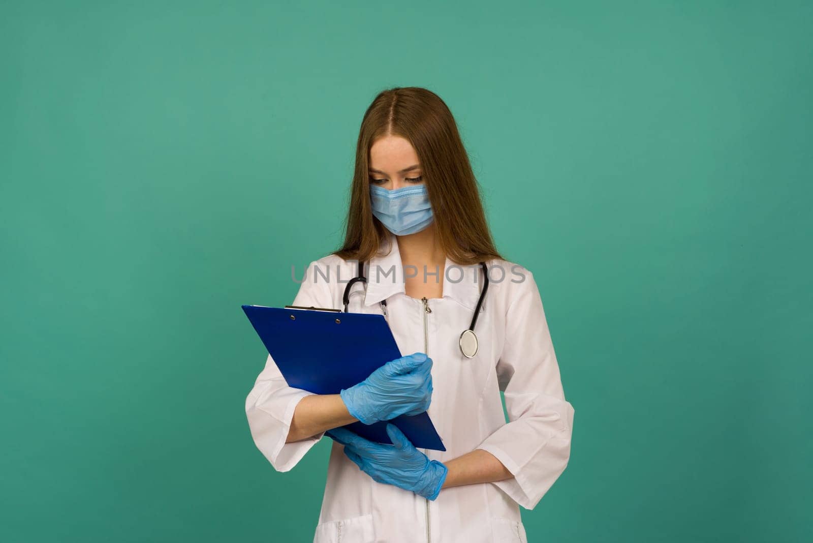 Covid19, coronavirus, healthcare. Portrait of professional confident young caucasian doctor in medical mask and white coat, stethoscope over neck, ready help patient, fight disease - image