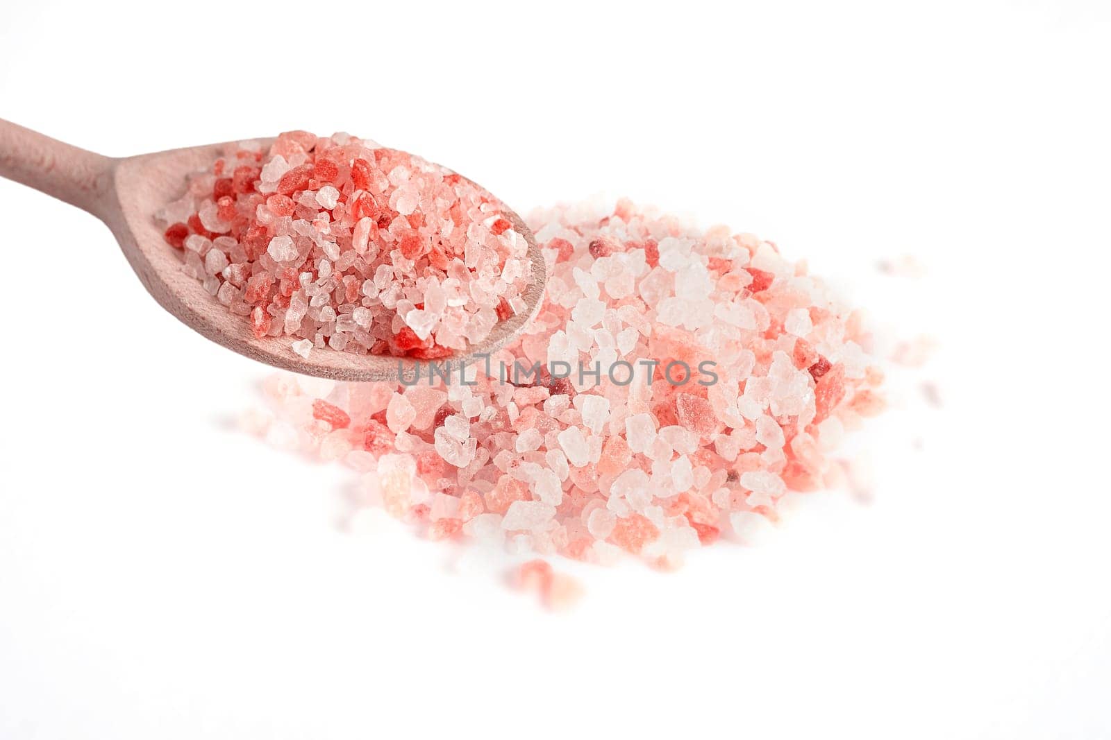 Pink Himalayan salt in wooden spoon on white background by Annavish