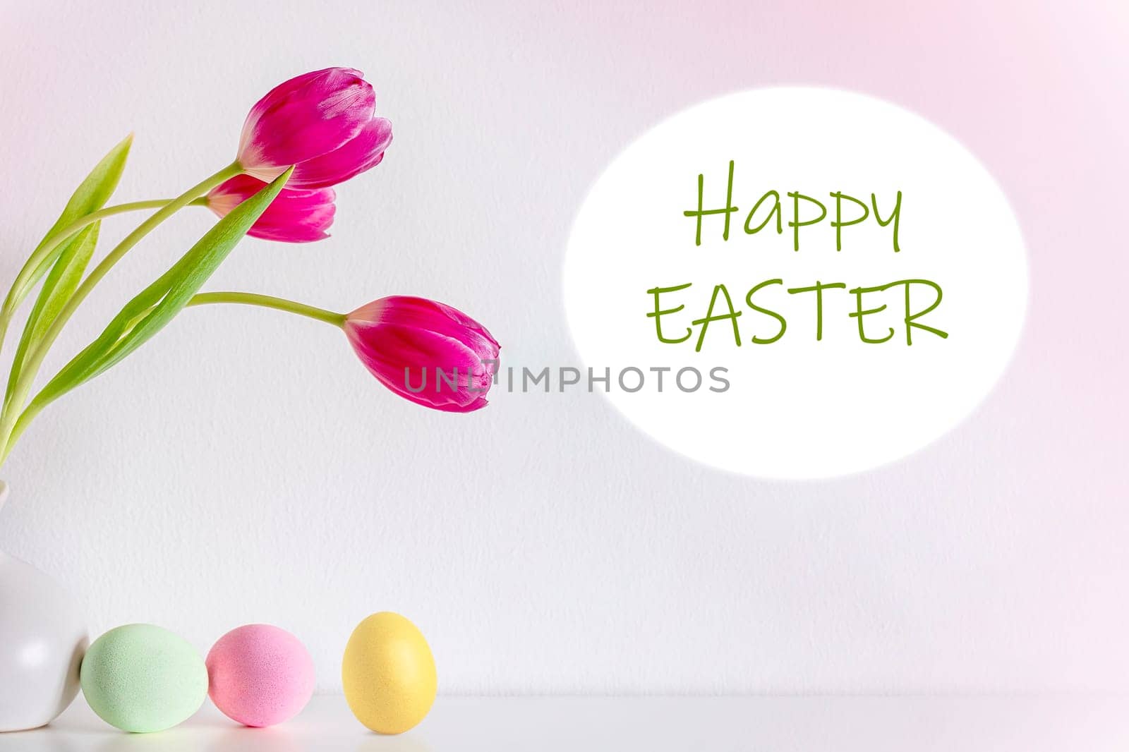 Spring pink tulip flowers with Easter eggs on pink background. Text