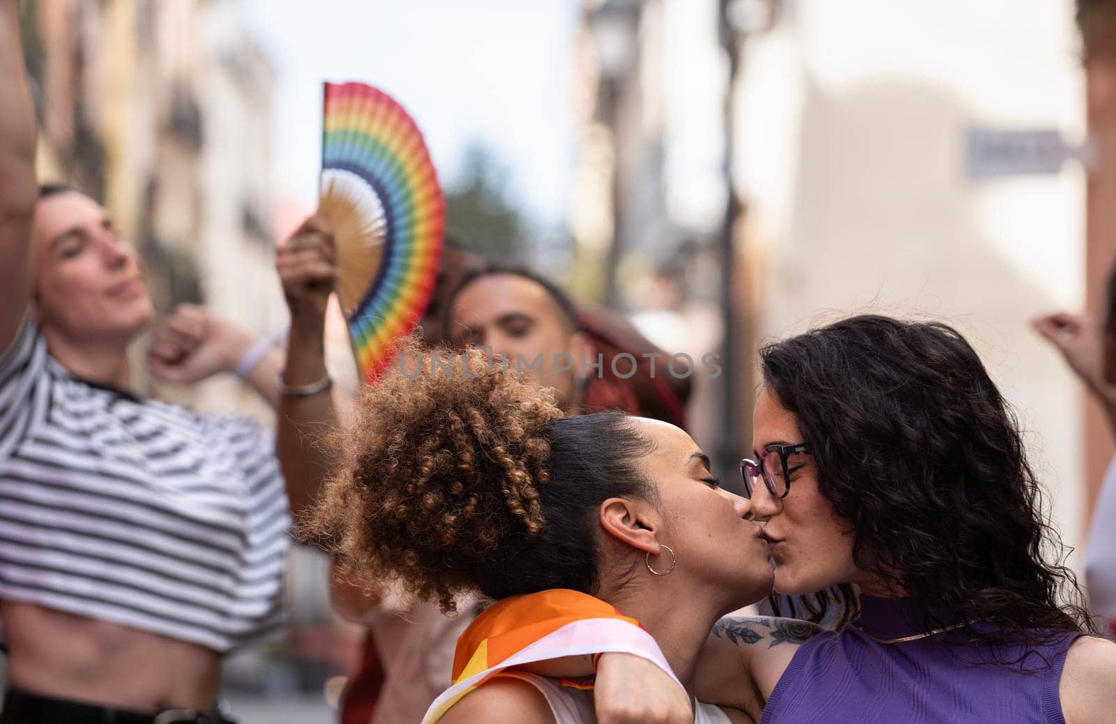 Group of LGBTQ people enjoy a pride event or parade celebration to support their community and moving towards equality by papatonic