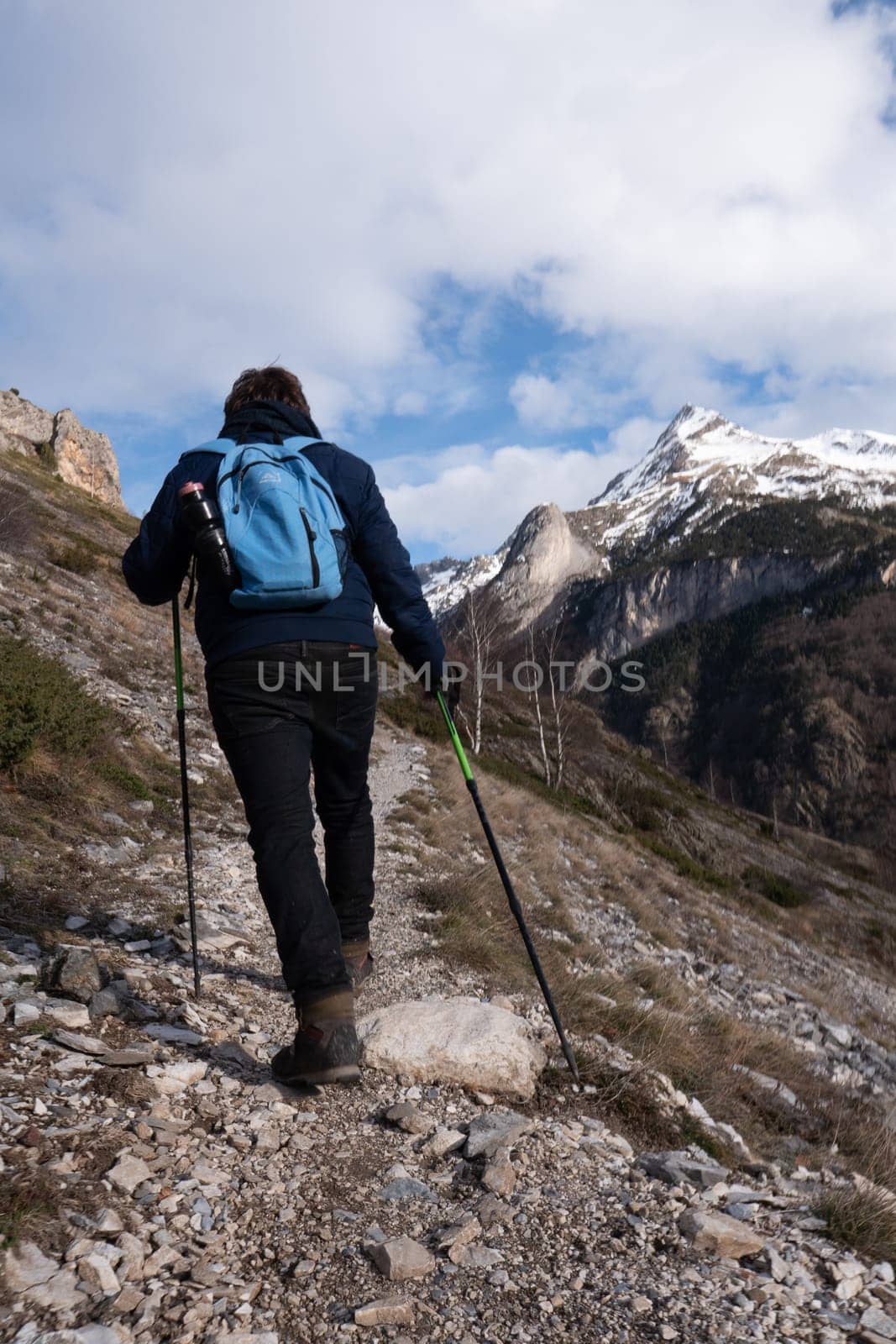 Hiker walking on the path in Pyrenees mountains near Gavarnie, High quality photo