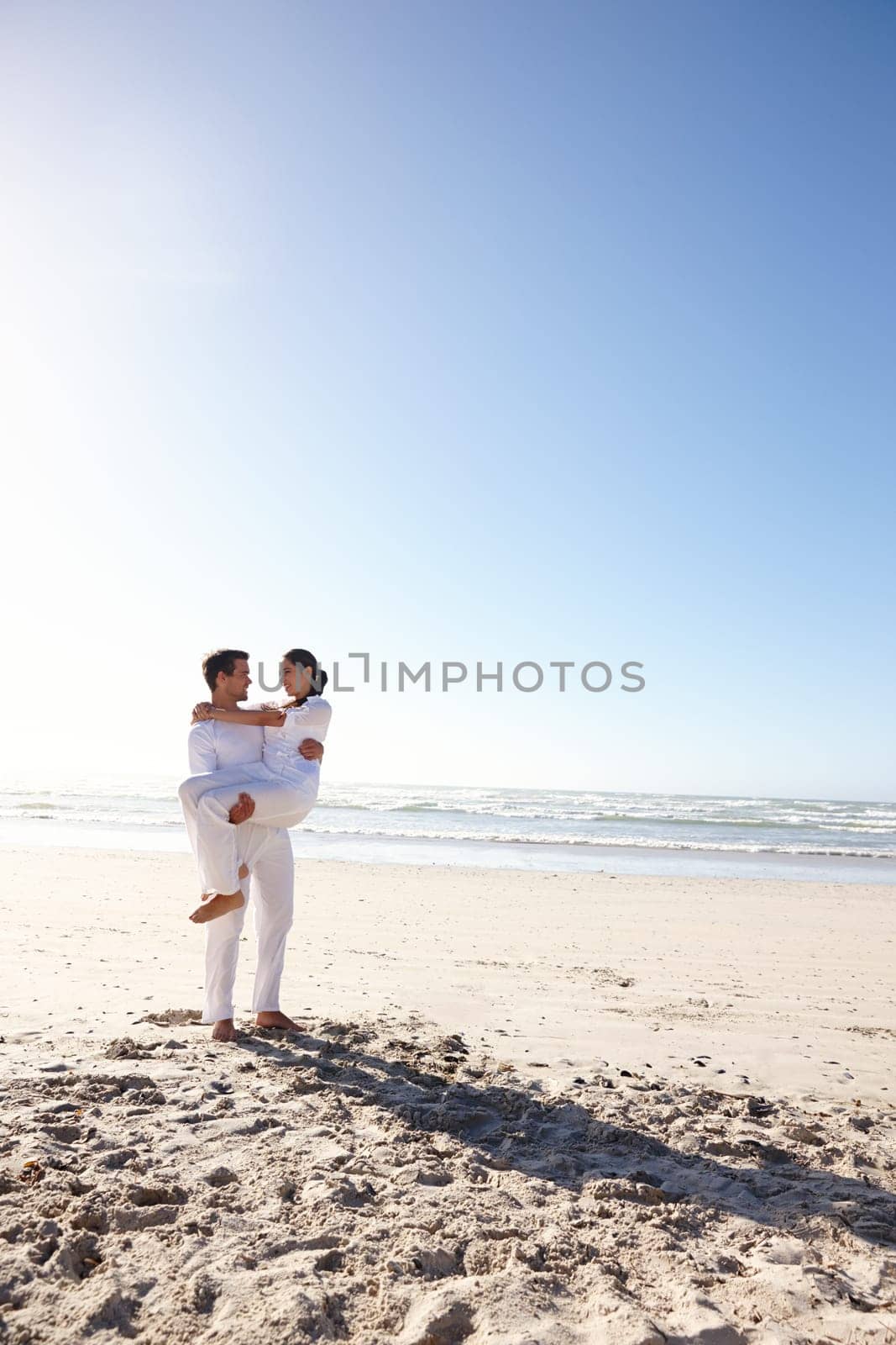 Couple, husband, wife and honeymoon on island and happy for getaway, travel and vacation in Bali. Man and woman and love for celebration, union and companionship at beach or seaside in Indonesia by YuriArcurs