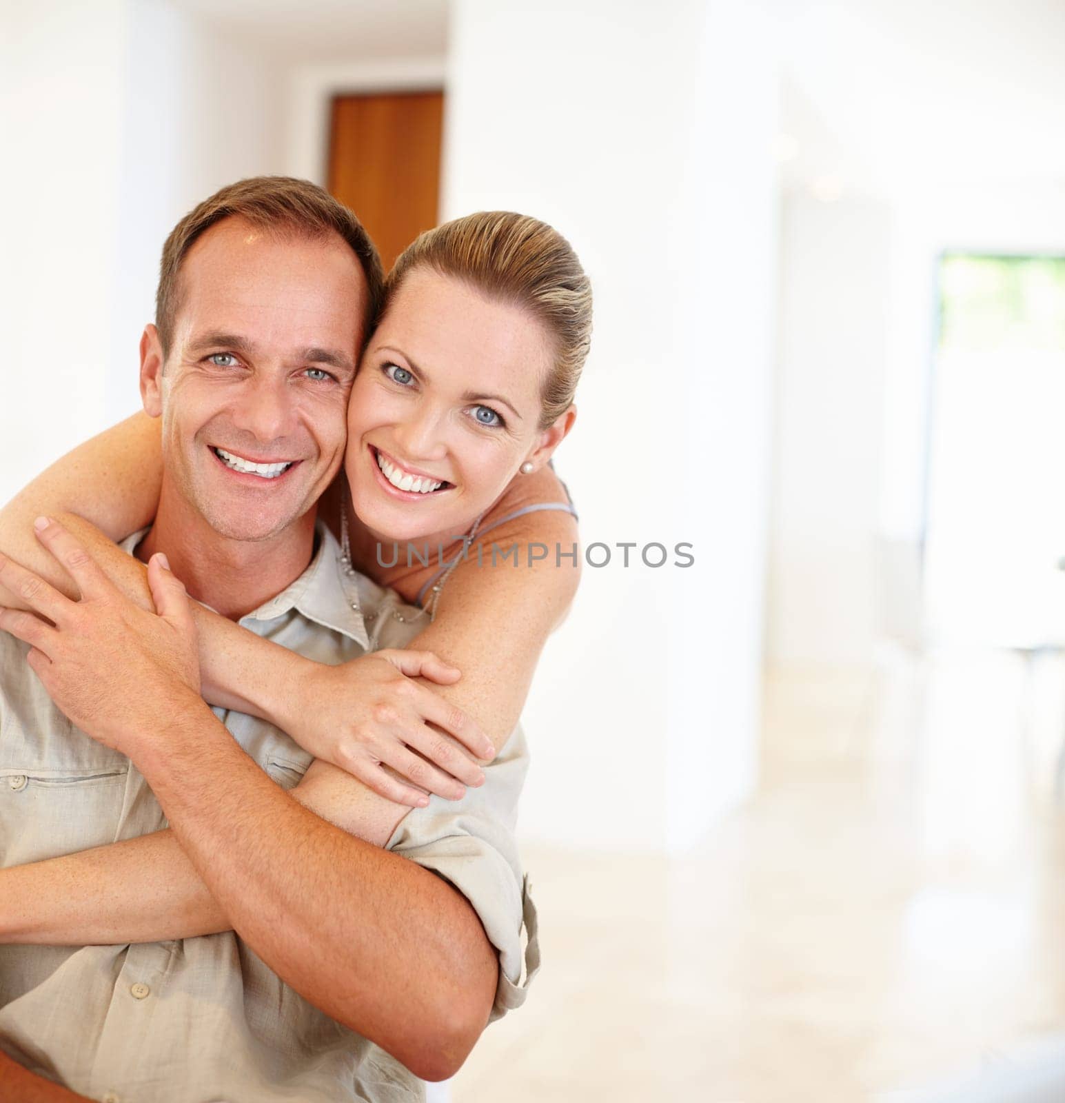 Smile, portrait and couple in hug for relationship, love and proud of marriage support in home. Happy, embrace and people for loyalty or commitment, romance and bonding in apartment for enjoyment.