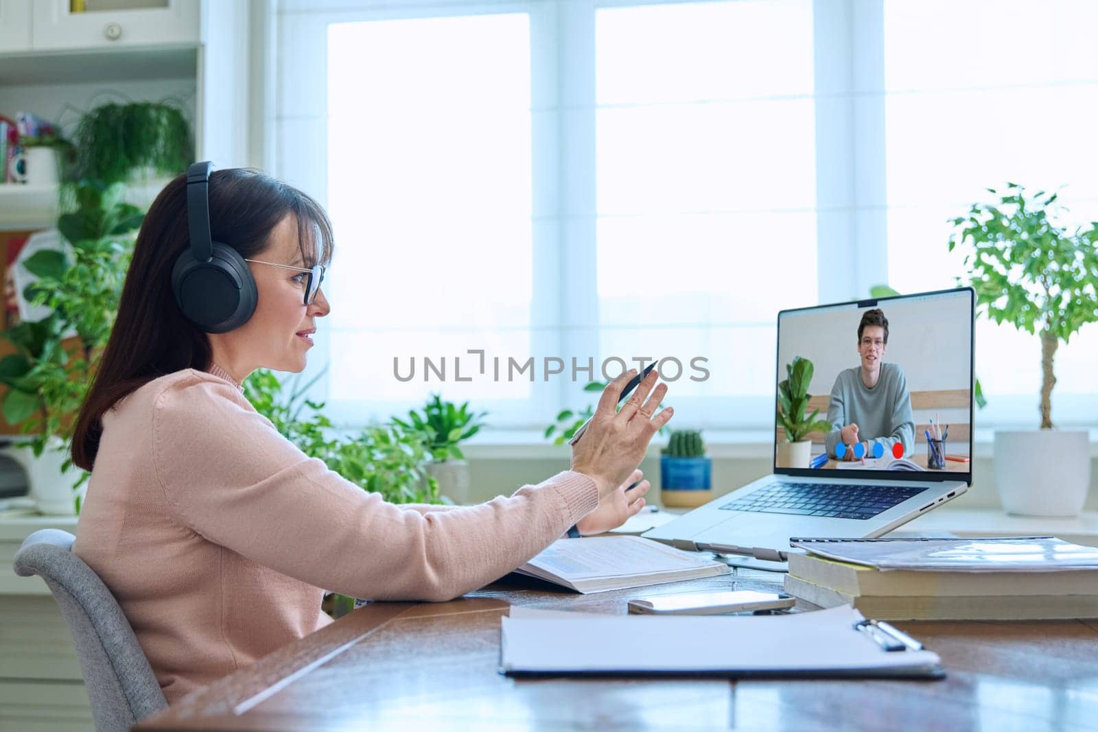 Female teacher having video conference, online test lesson with college student guy. Remote meeting, consultation, training, education, technology concept