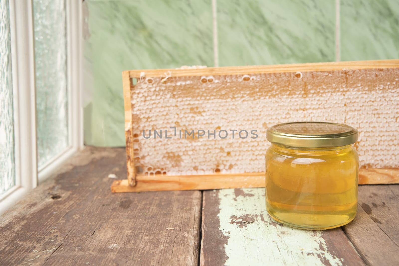 full honeycomb and jar of honey, organic fortified beekeeping product for healthy eating, alternative medicine, high quality photo