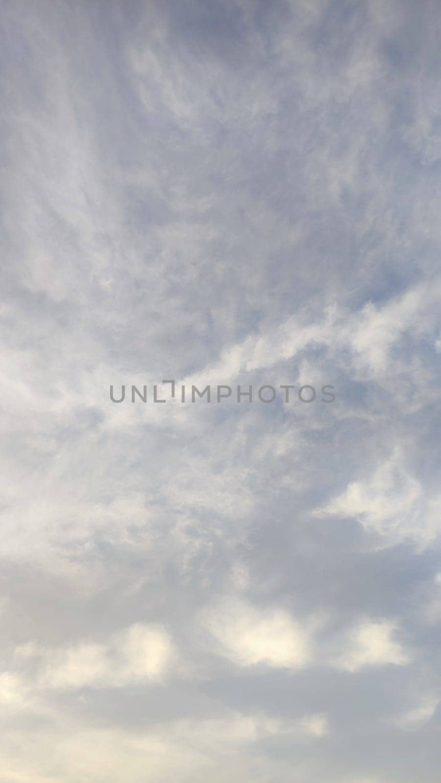 Blue gray light sky nature white clouds whether background, sun face . High quality photo