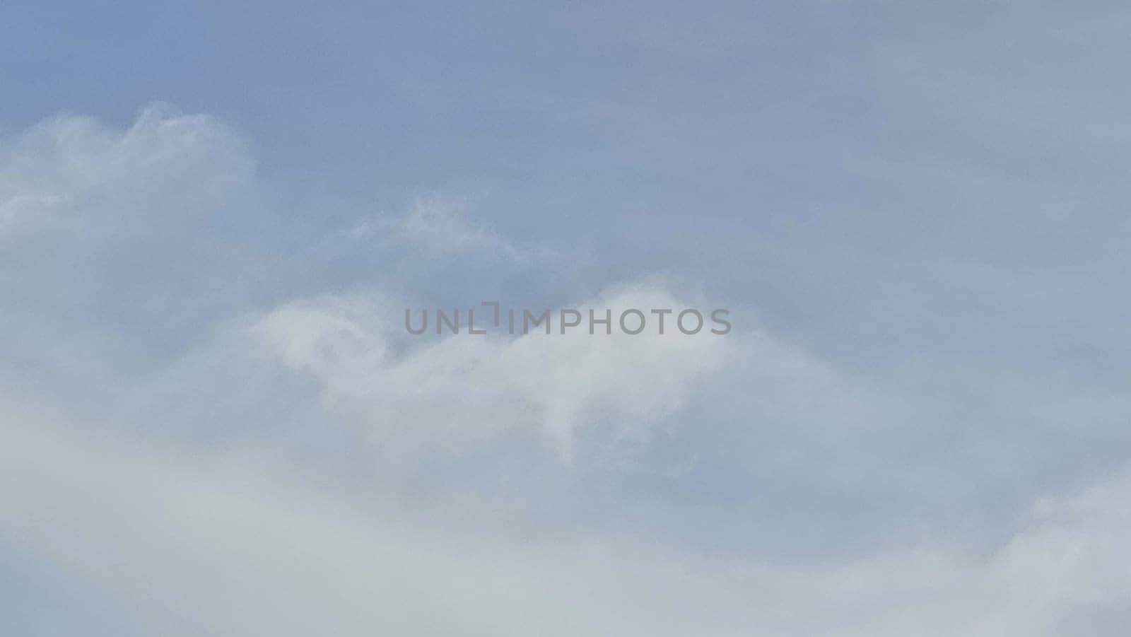 Blue gray light sky nature white clouds whether background, sun face . High quality photo