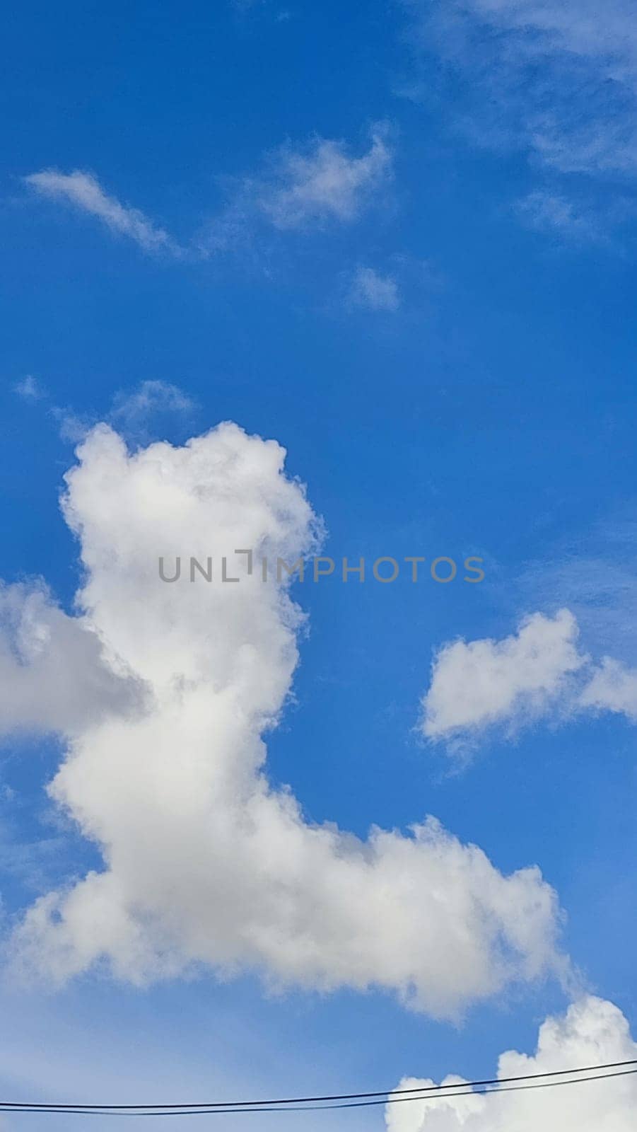 Blue gray light sky nature white clouds whether background, sun face . High quality photo