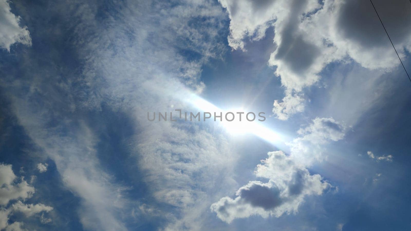 Blue gray light sky nature white clouds whether background, sun face . High quality photo