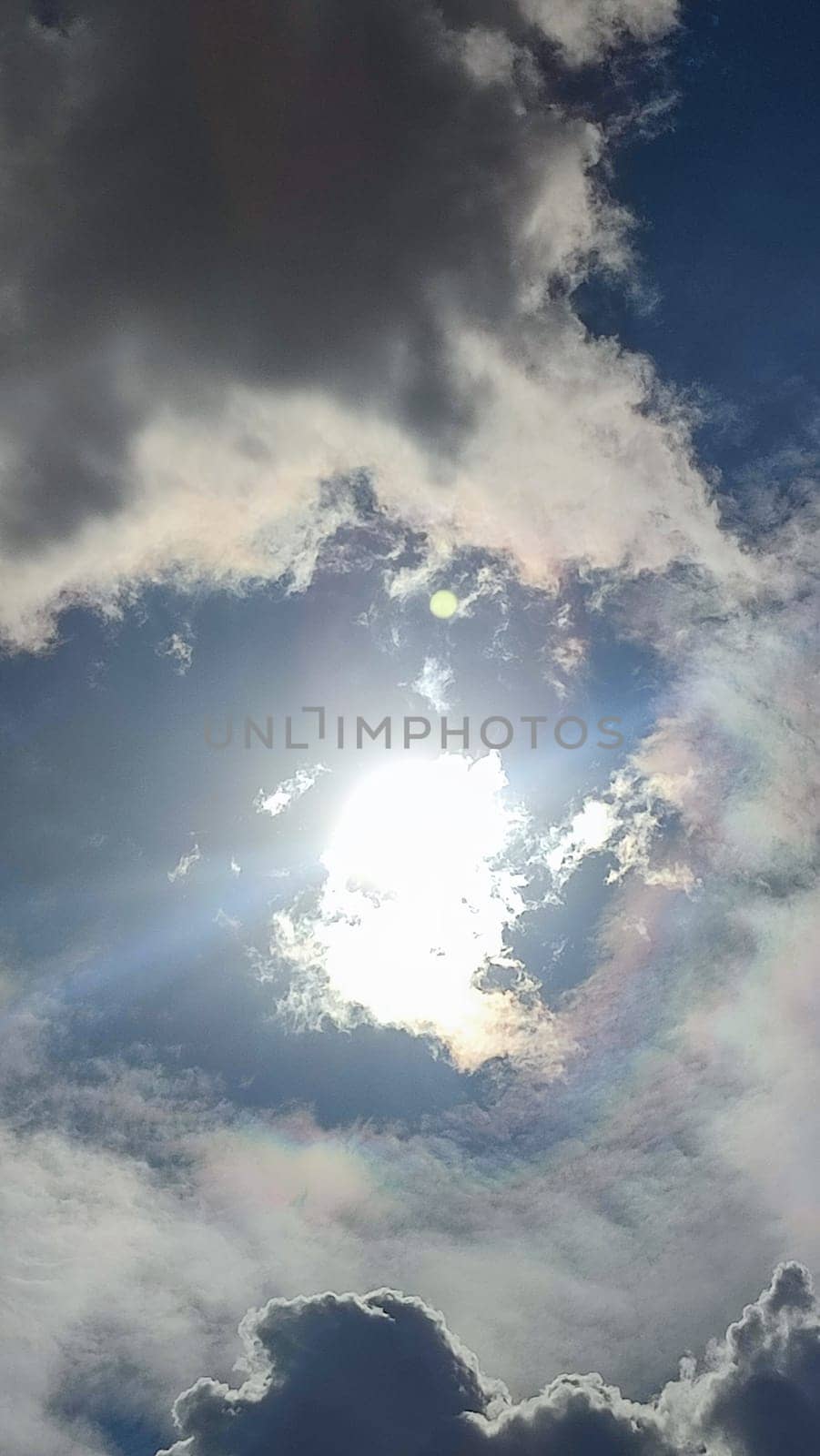Blue gray light sky nature white clouds whether background, sun face . High quality photo