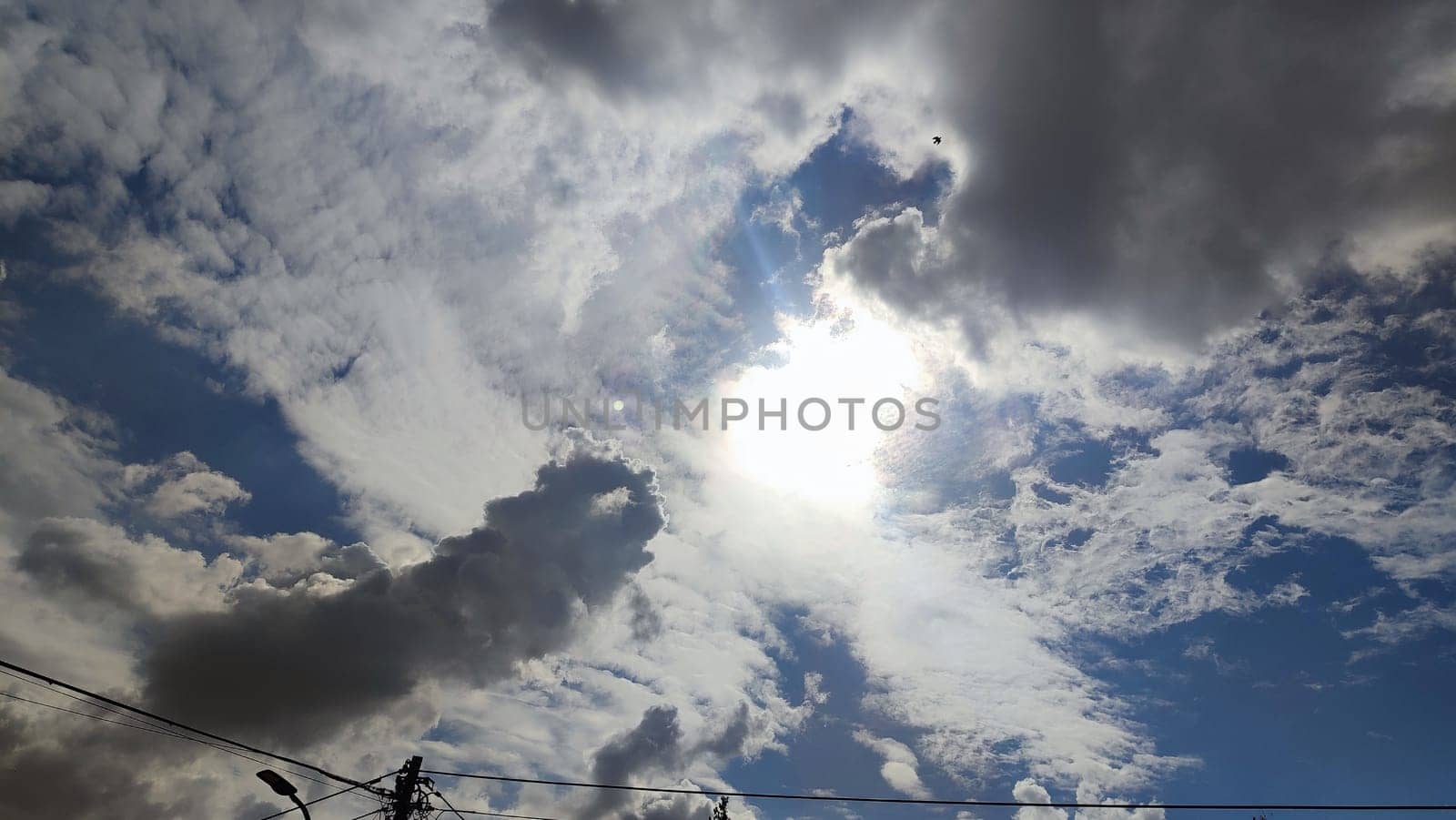 Blue gray light sky nature white clouds whether background, sun face . High quality photo