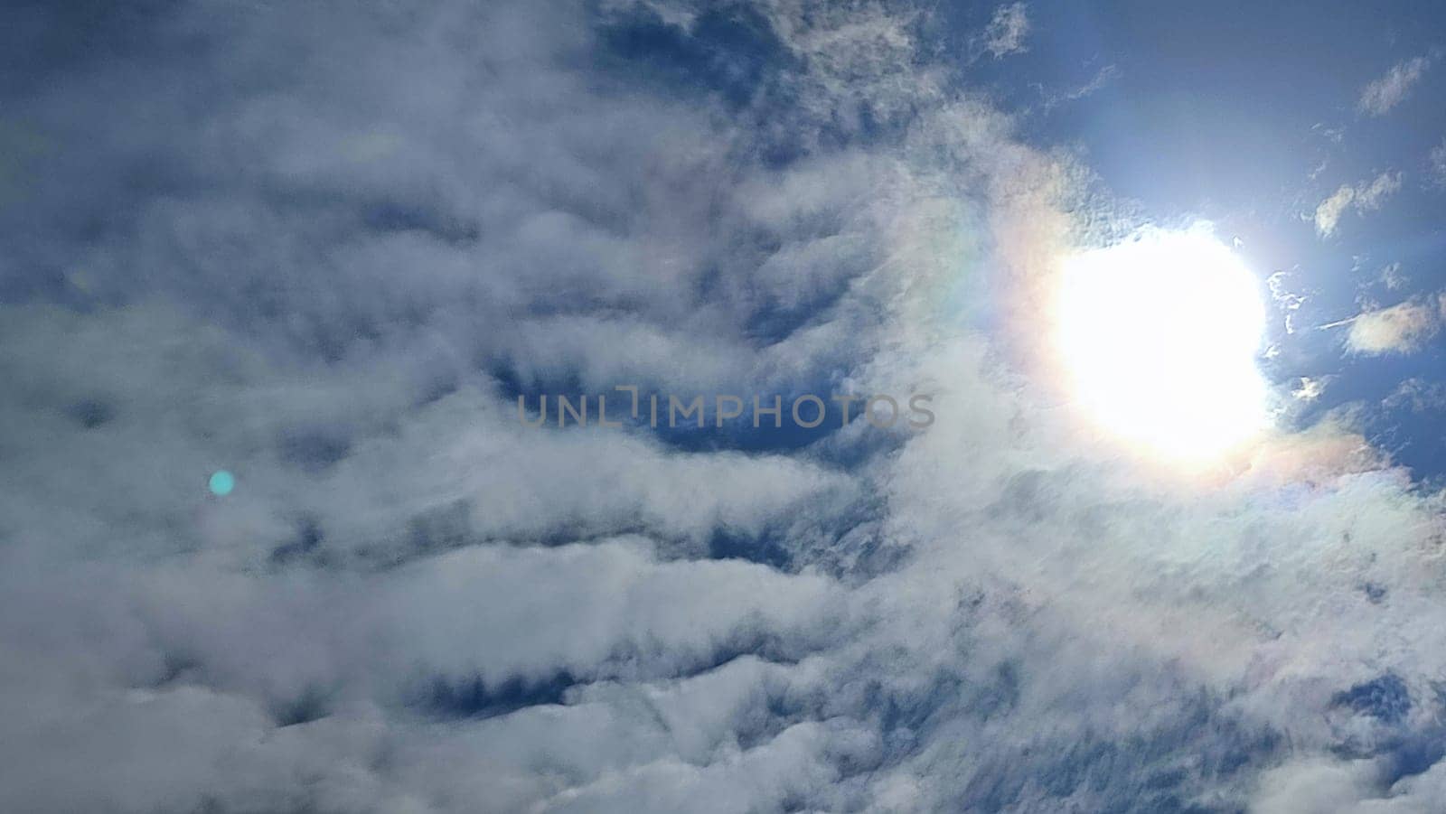 Blue gray light sky nature white clouds whether background, sun face . High quality photo