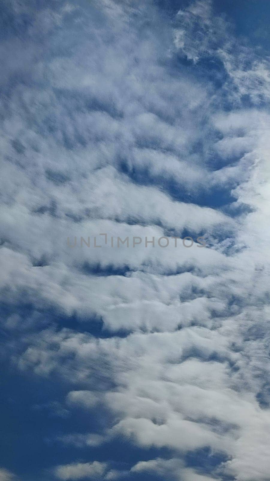 Blue gray light sky nature white clouds whether background, sun face . High quality photo