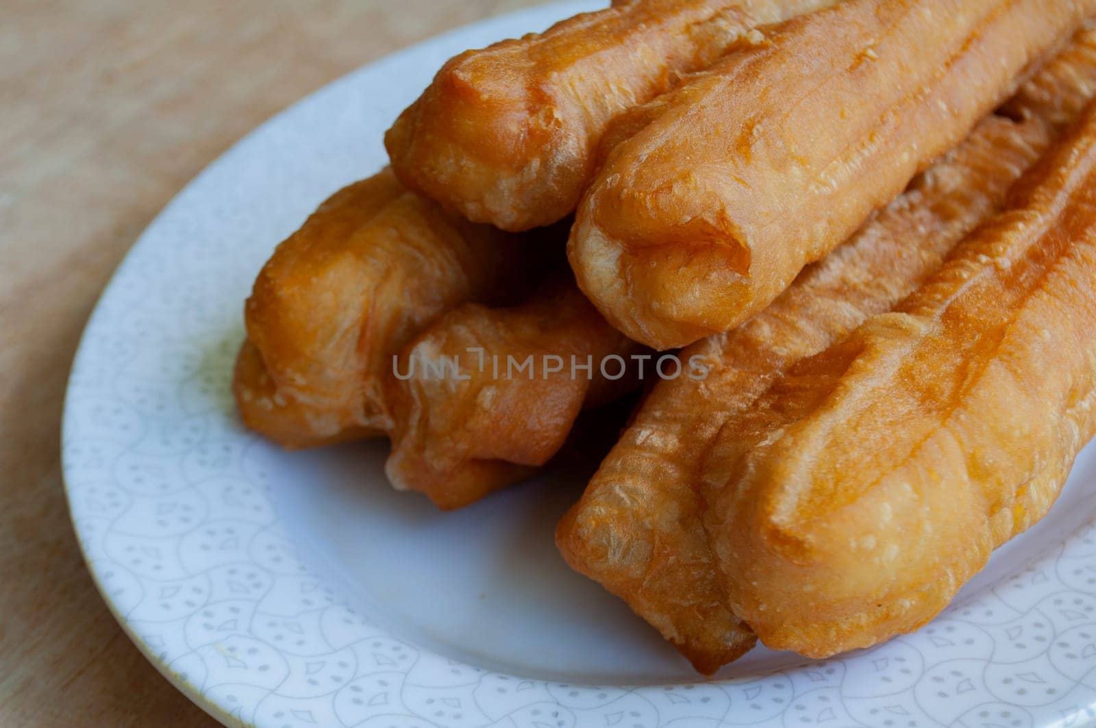 Delicious cakoi or youtiao cake on white plate. Asian food concept