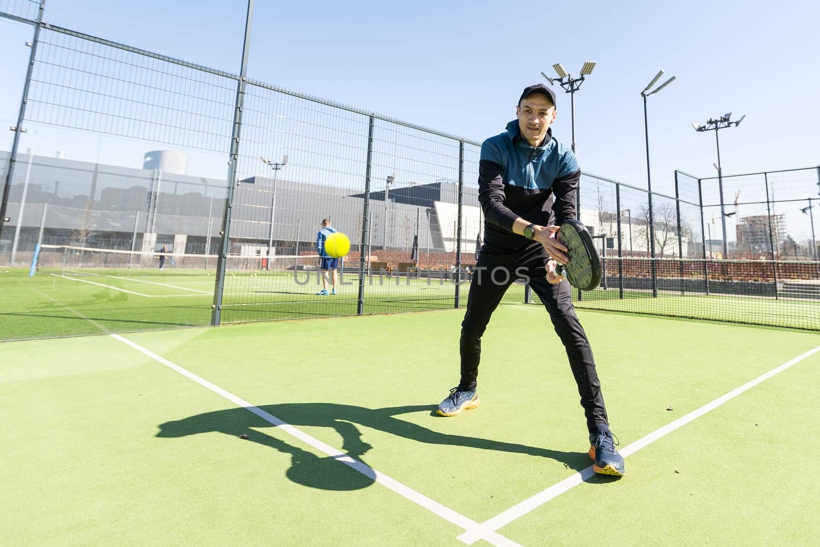 Man playing paddle tennis. Jumping and shooting the ball. High quality photo