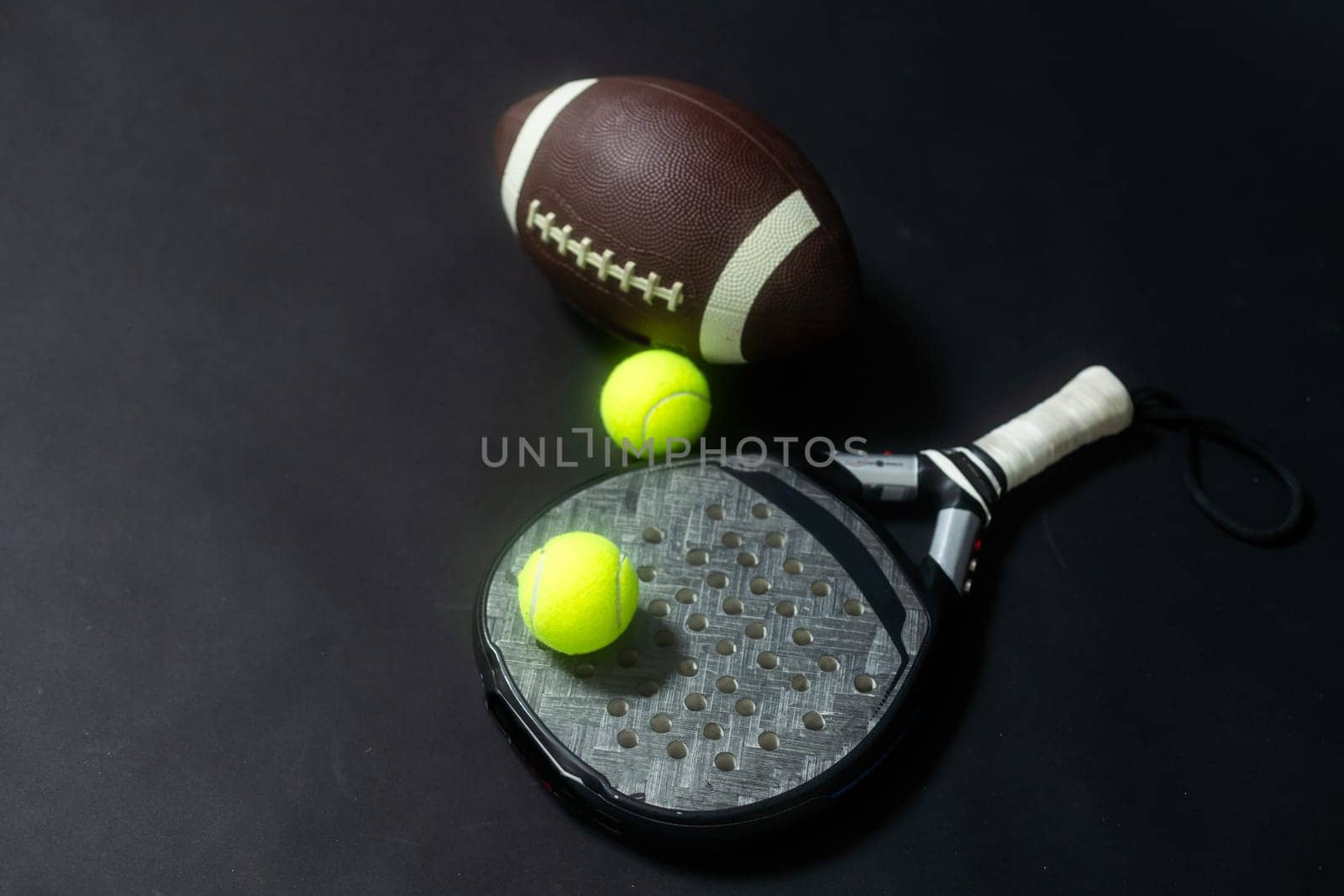 Set of sport equipment on floor, padel tennis, ball rugby. High quality photo