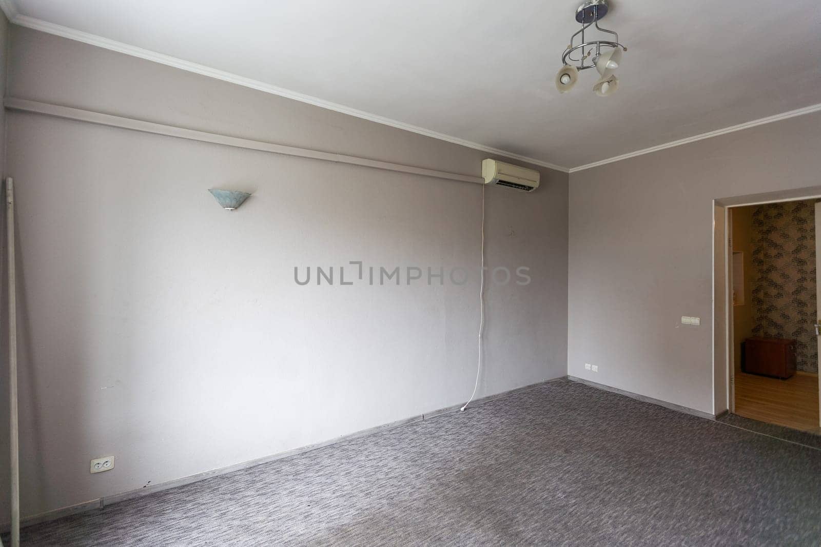 Empty room with all white walls and parquet floor. Nobody inside the room. High quality photo