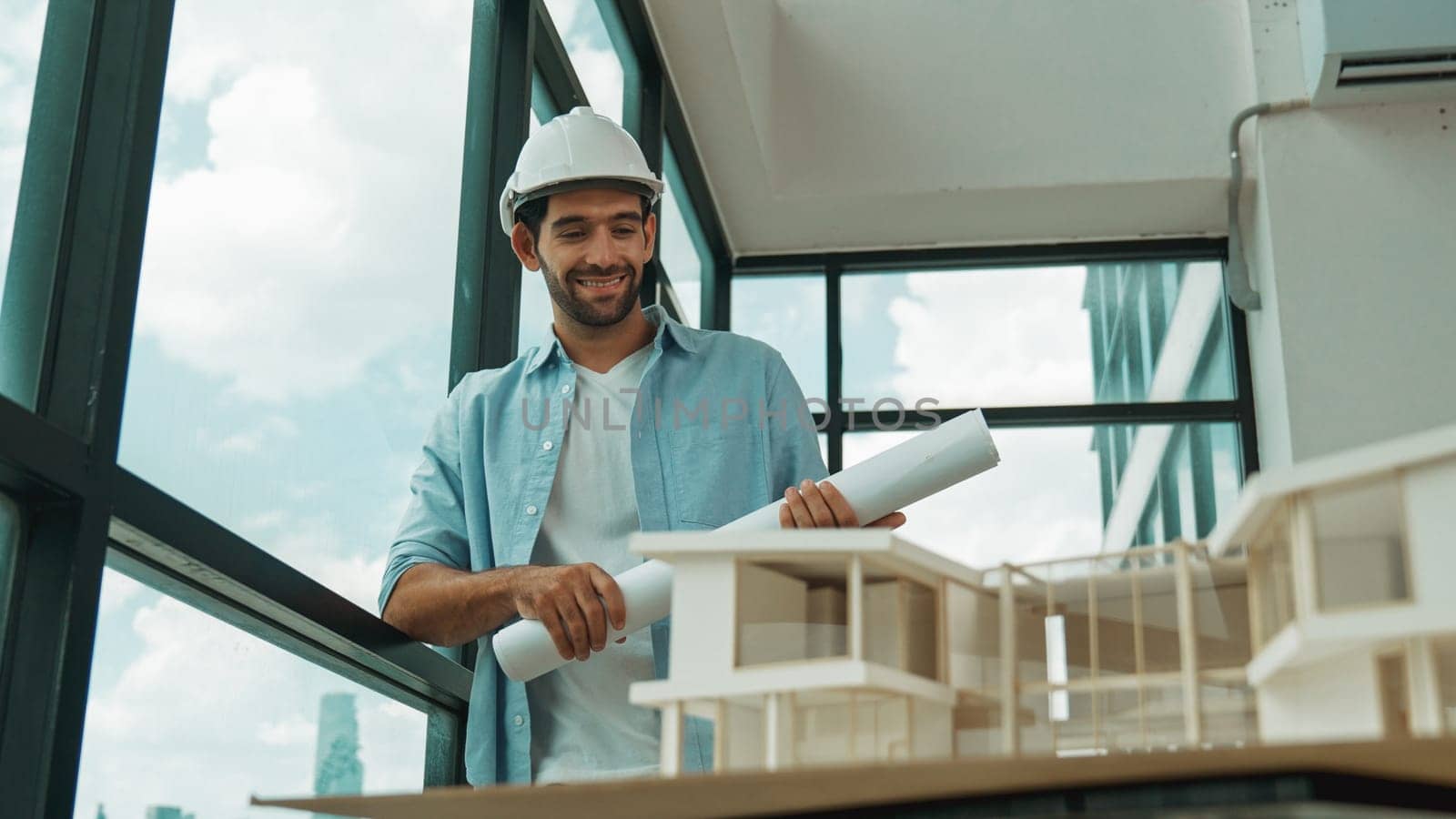 Civil engineer standing, walking while looking at house model. Tracery by biancoblue