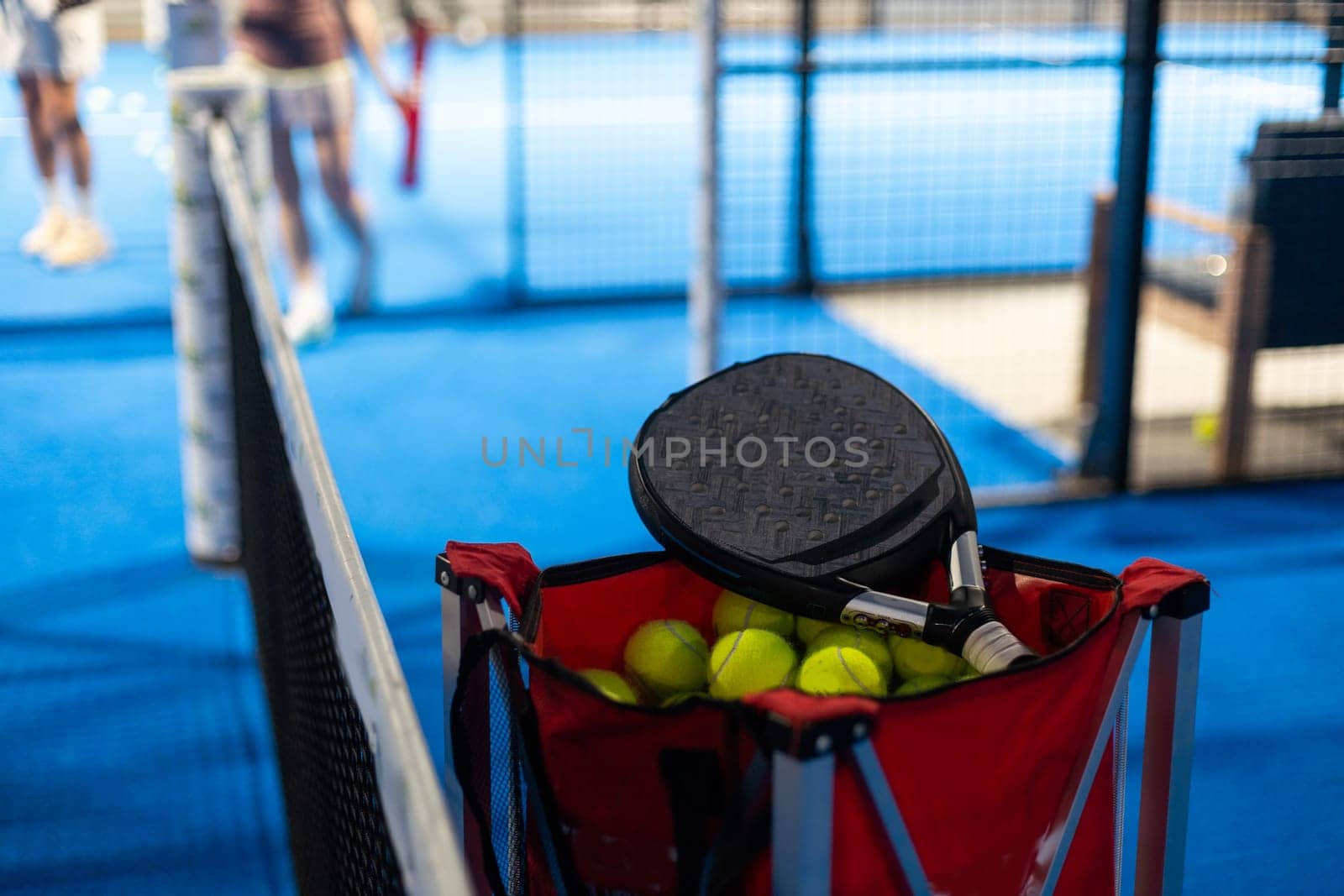 rackets and paddle balls on a court ready to play by Andelov13
