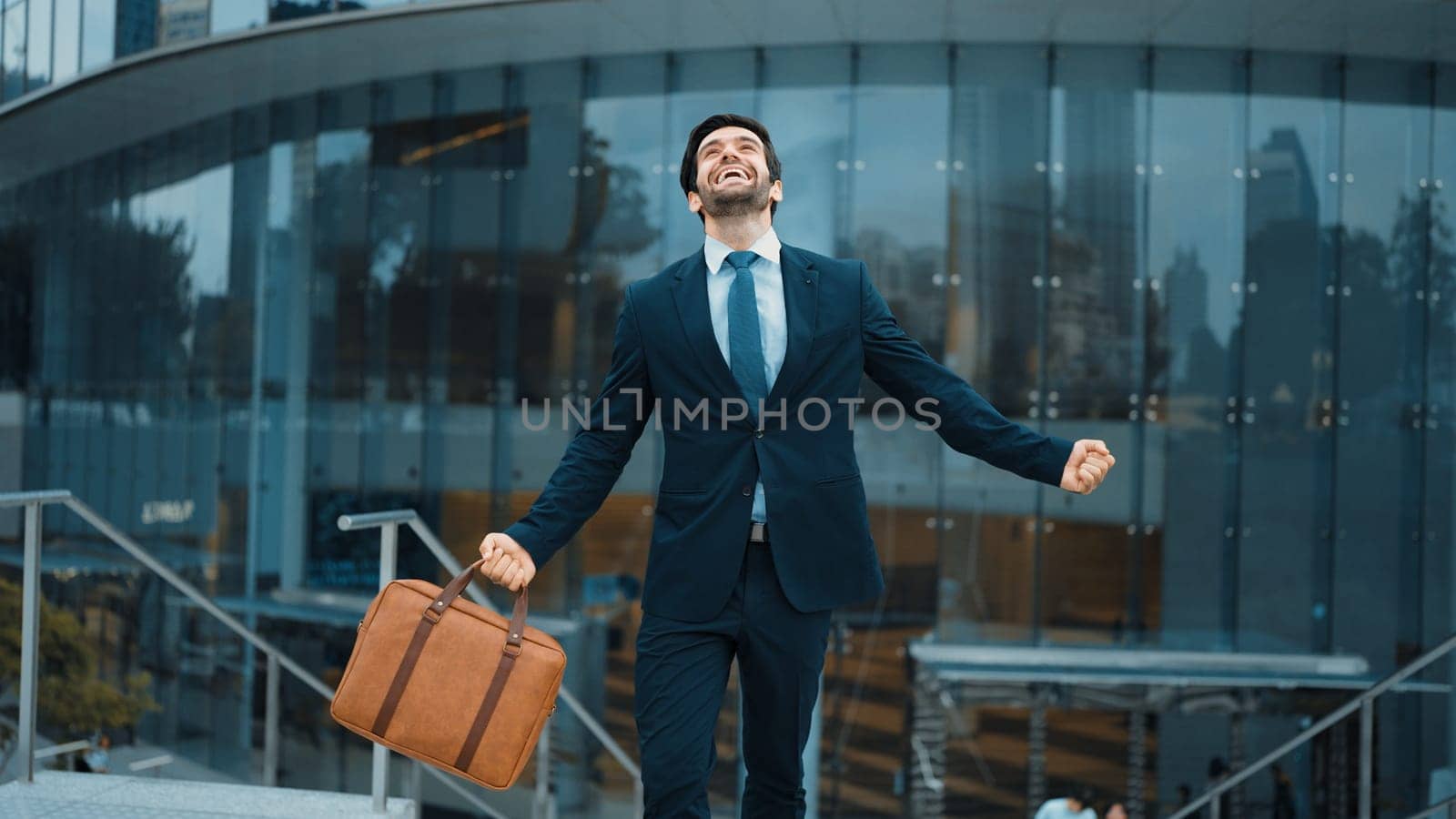 Successful businessman celebrate for getting promotion while walking. Exultant. by biancoblue