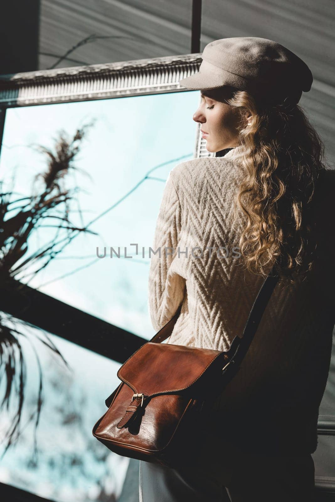 beautiful curly blond hair woman posing with a small brown near grey wall by Ashtray25