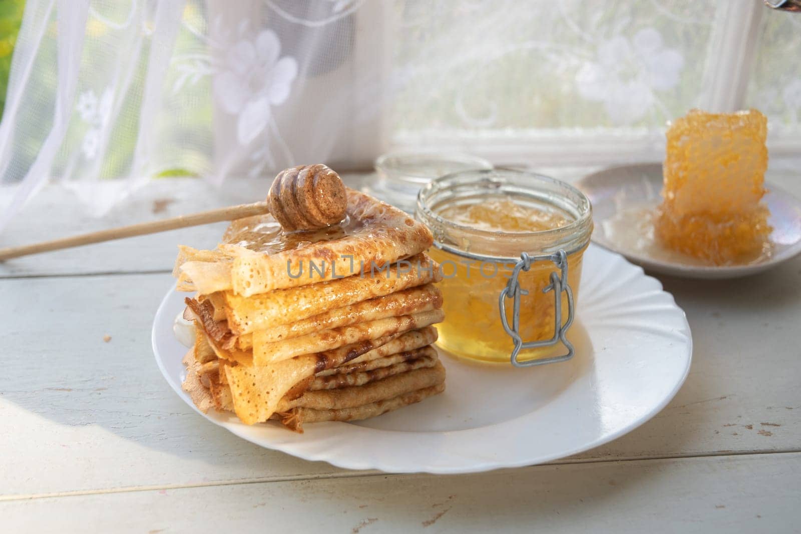 Russian pancakes with honey and a cup of tea from a vintage samovar Maslenitsa festival concept, High quality photo