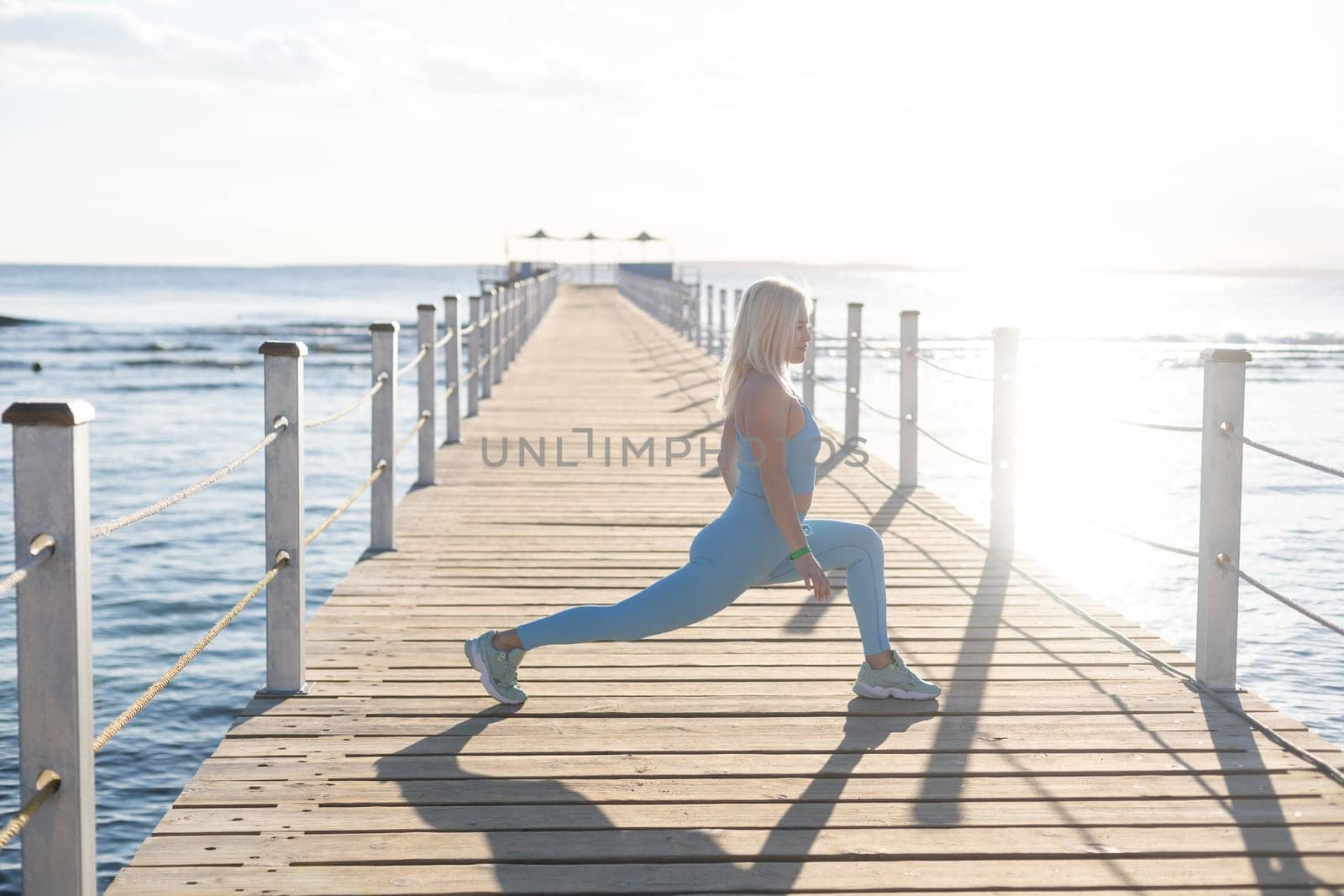 woman exercising on pontoon Red Sea.