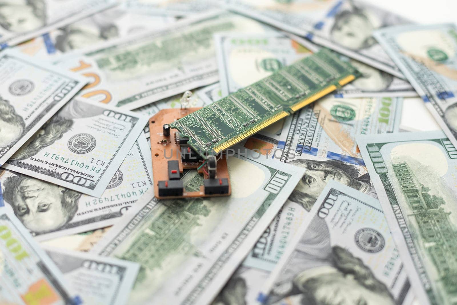 American dollars on the background of a printed circuit board, electronic semiconductor microcircuit. The concept of electronic money, blockchain, cryptocurrency by Andelov13