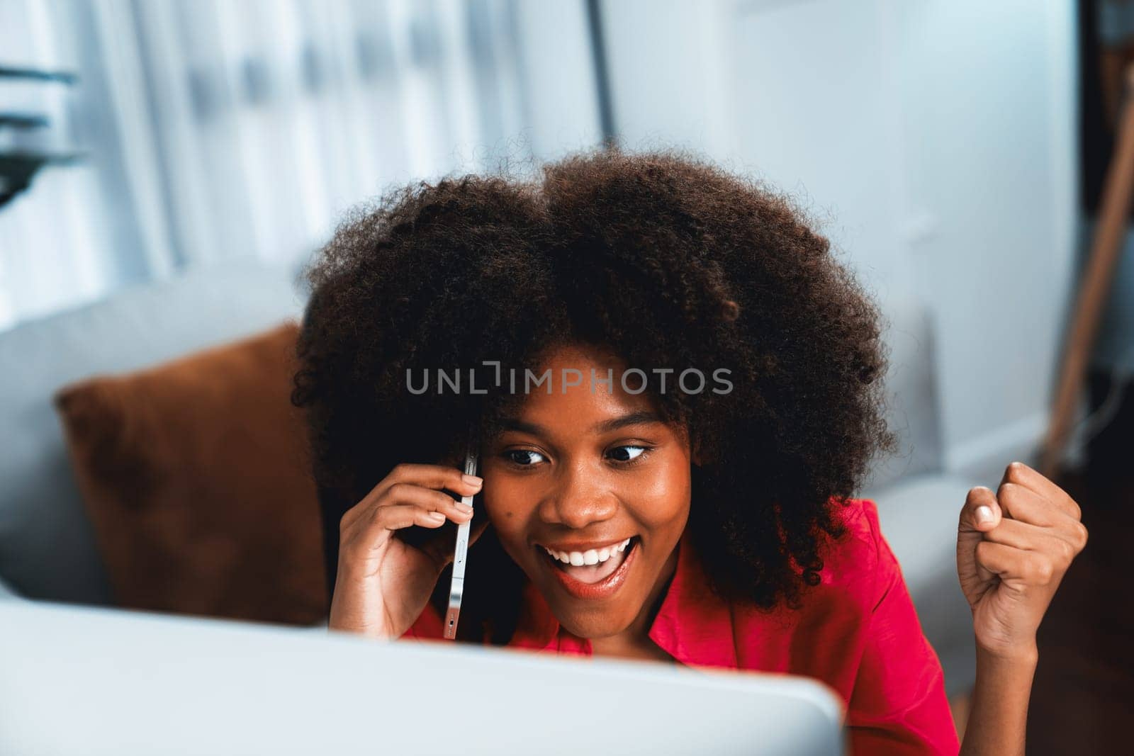 African woman blogger talking with coworker or friend on the phone. Tastemaker. by biancoblue
